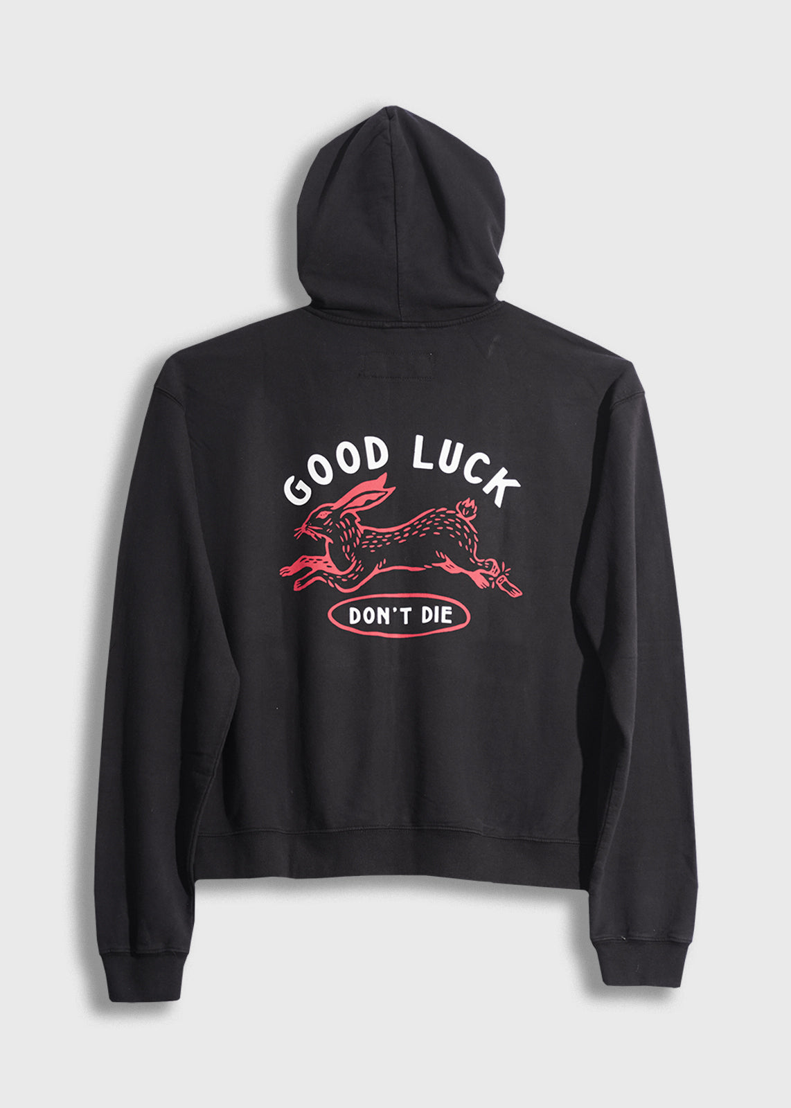 Black hoodie with "Good Luck Don't Die" and red rabbit design on back, conveying a bold, playful message.