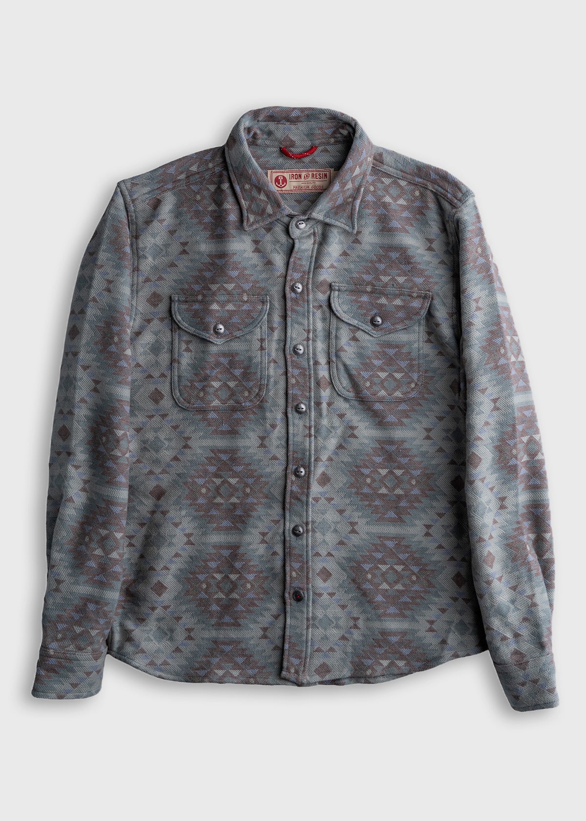 Gray patterned shirt with geometric design, buttoned front, and two chest pockets, displayed on a plain background.