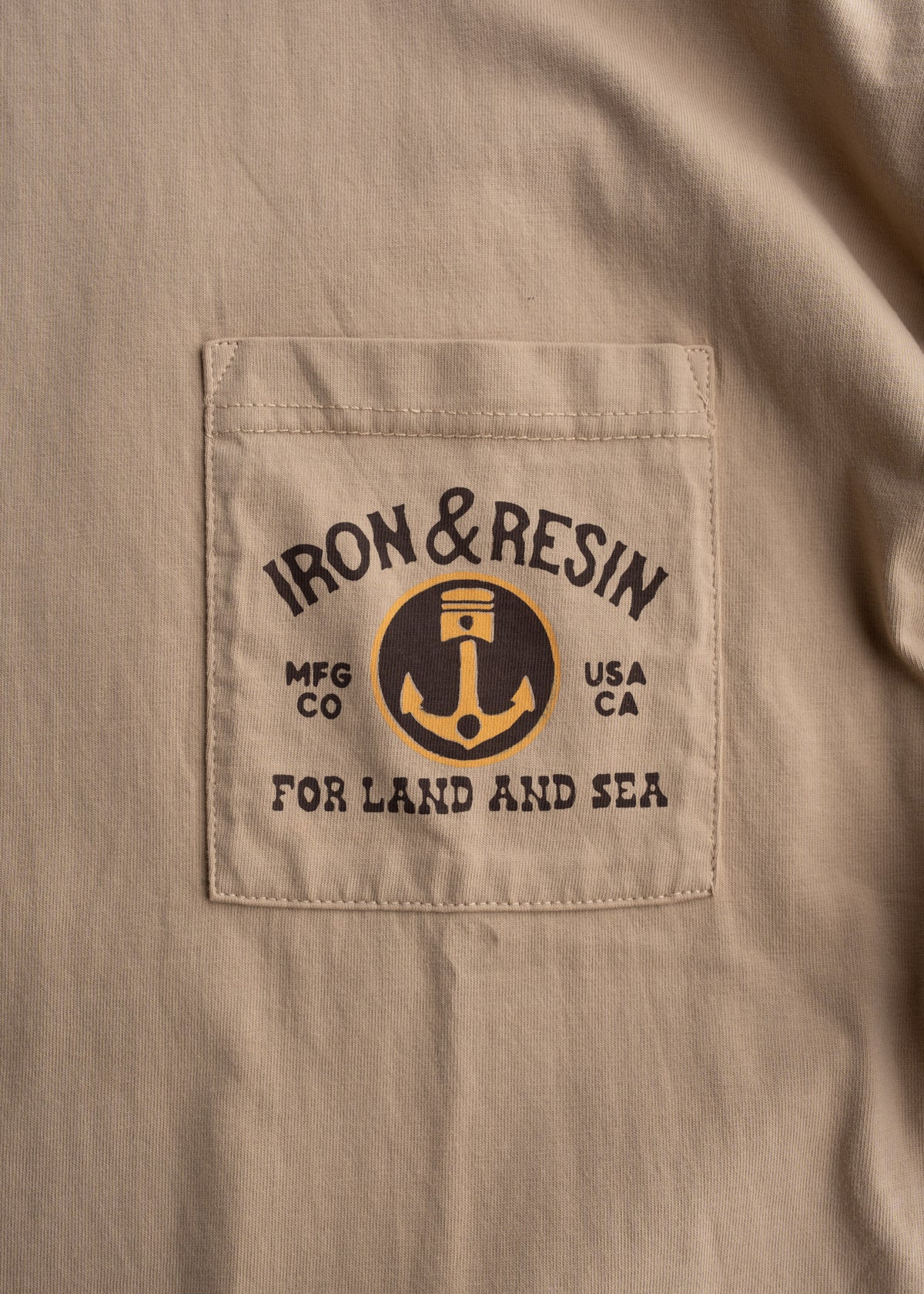 Men’s 7.5 oz heavyweight jersey cotton t-shirt in Tan with chest pocket and custom graphic print