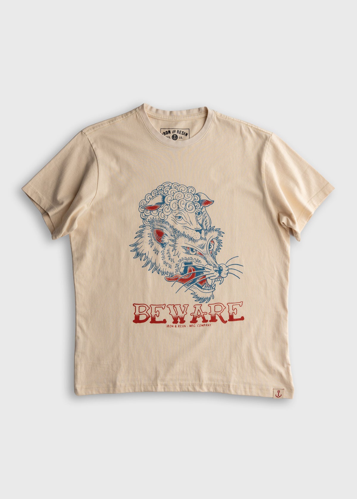 Beige T-shirt with a fierce wolf illustration and "BEWARE" text in red. Iron & Resin logo inside the collar.