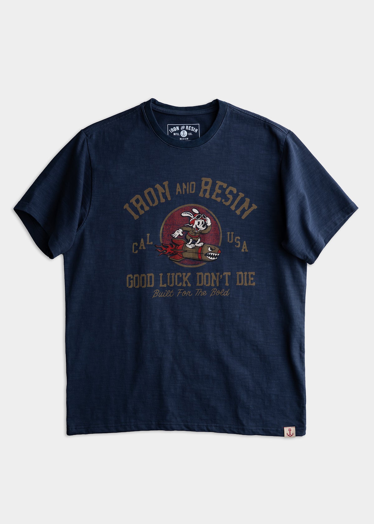Navy blue T-shirt with "Iron and Resin" logo, cartoon character, and "Good Luck Don't Die" text. Casual and bold design.