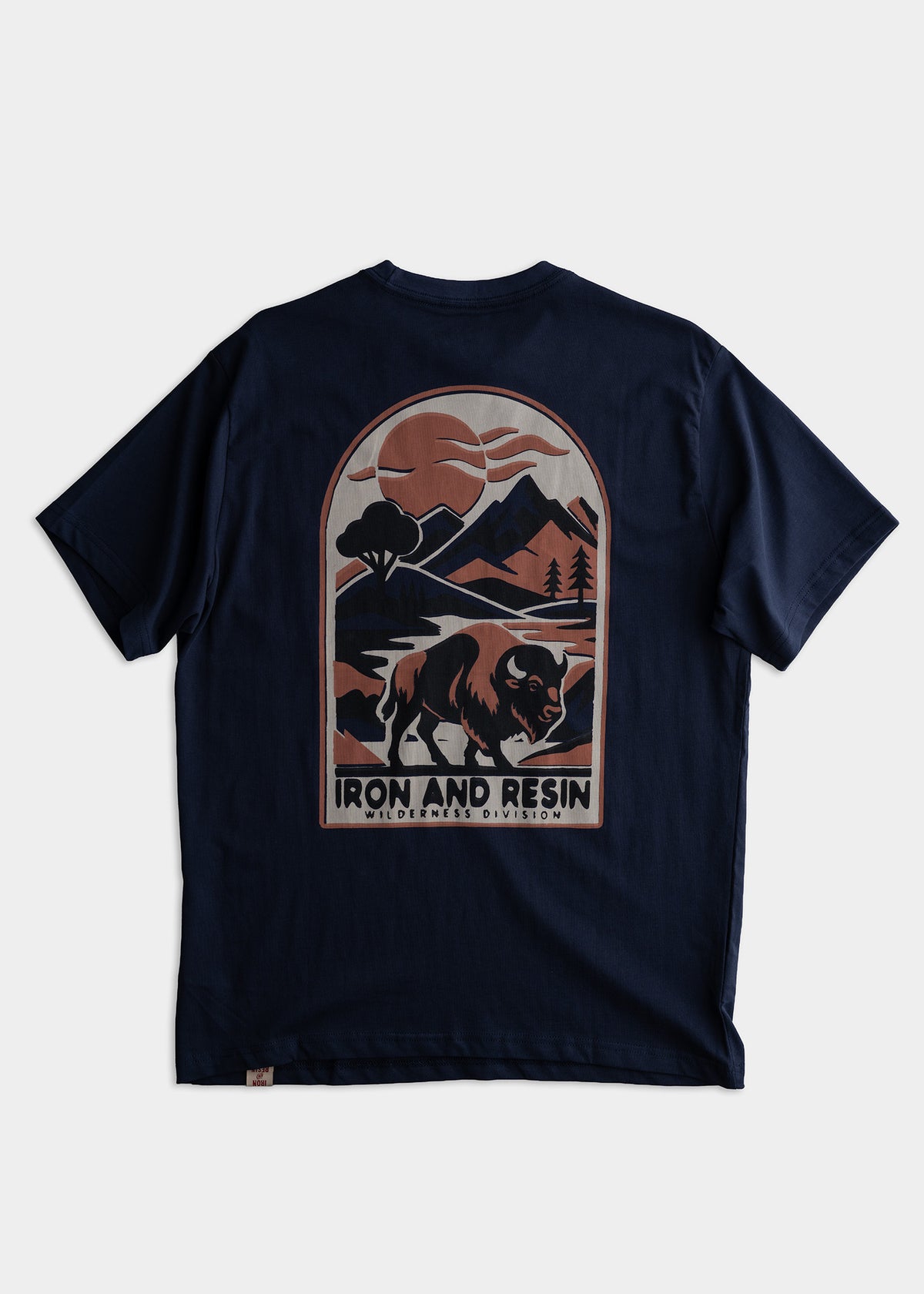 Navy t-shirt with a mountain and bison graphic, labeled "Iron and Resin Wilderness Division," under a stylized sun and clouds.