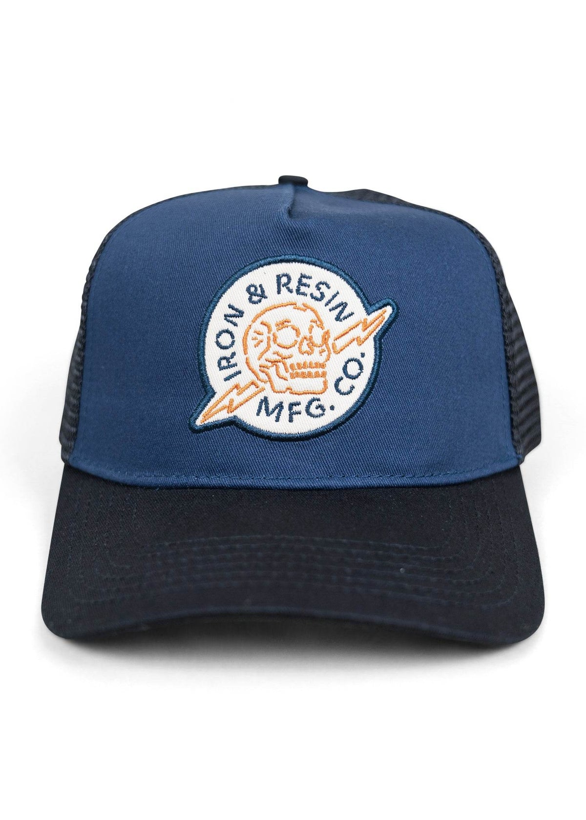 Blue trucker hat with "Iron & Resin MFG. CO" logo featuring a skull and lightning bolts, on a white background.