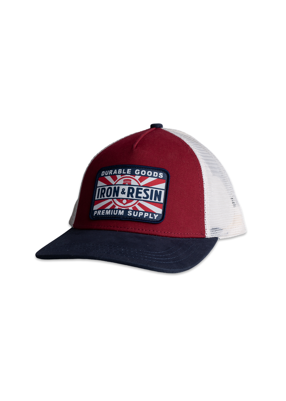 Red and white trucker hat with a navy brim, featuring an "Iron & Resin" patch labeled "Durable Goods, Premium Supply.