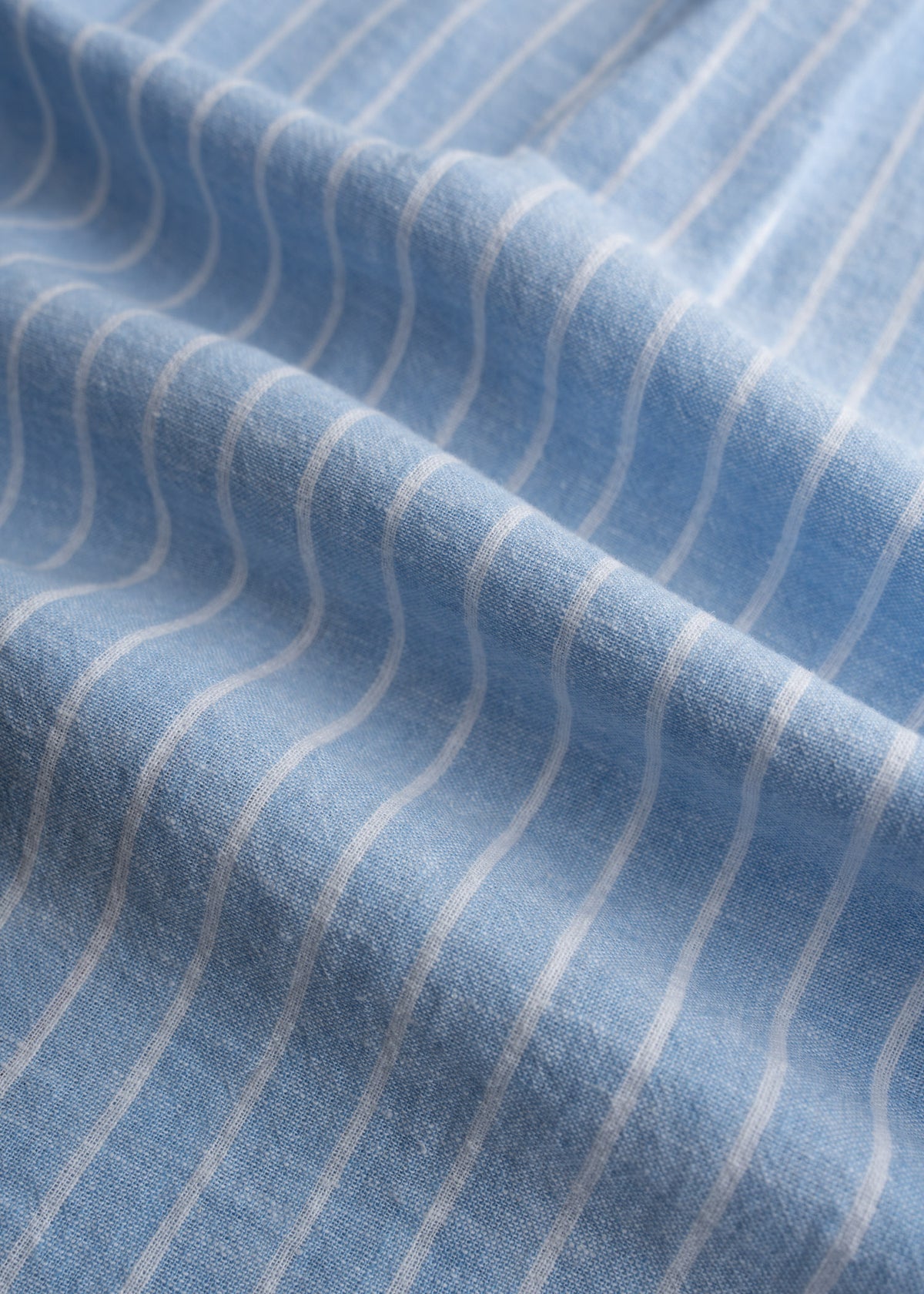 Close up of linen cotton blend fabric showing lightweight breathable weave and natural texture