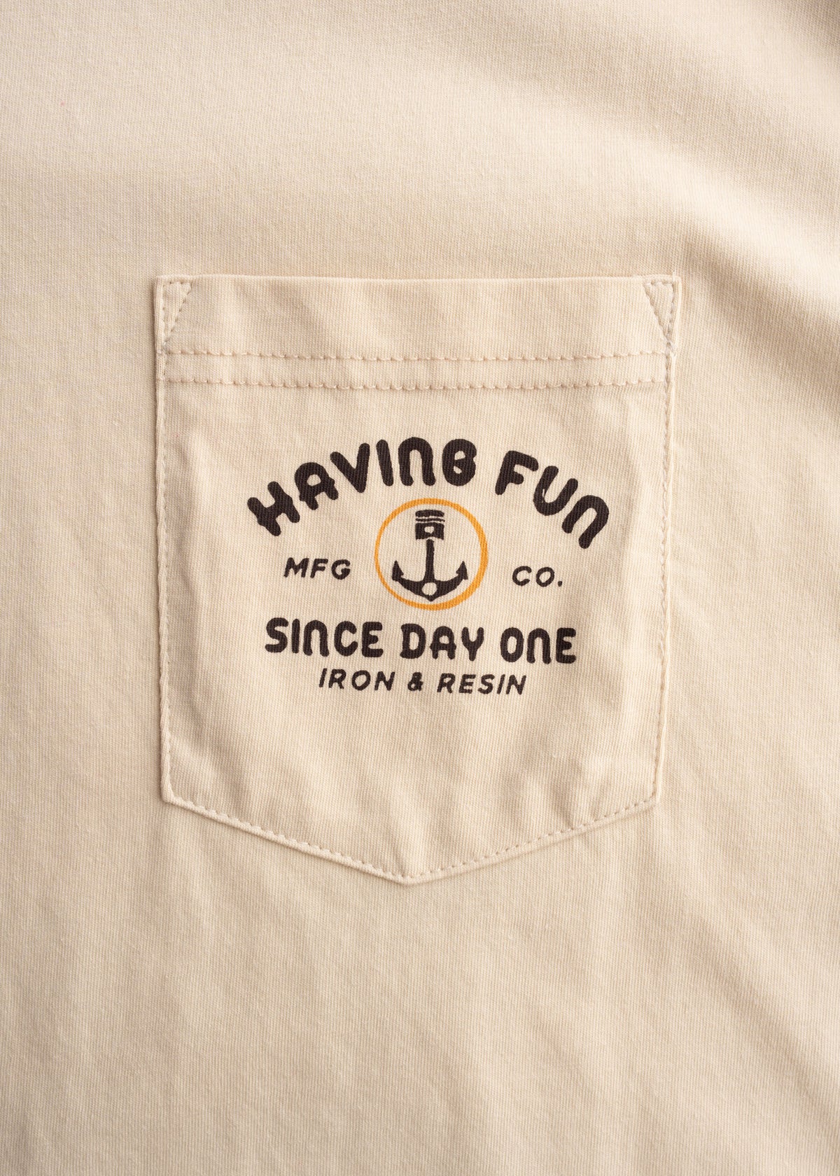 Close up of chest pocket, and custom graphic print on cotton t shirt, highlighting print detail and finish