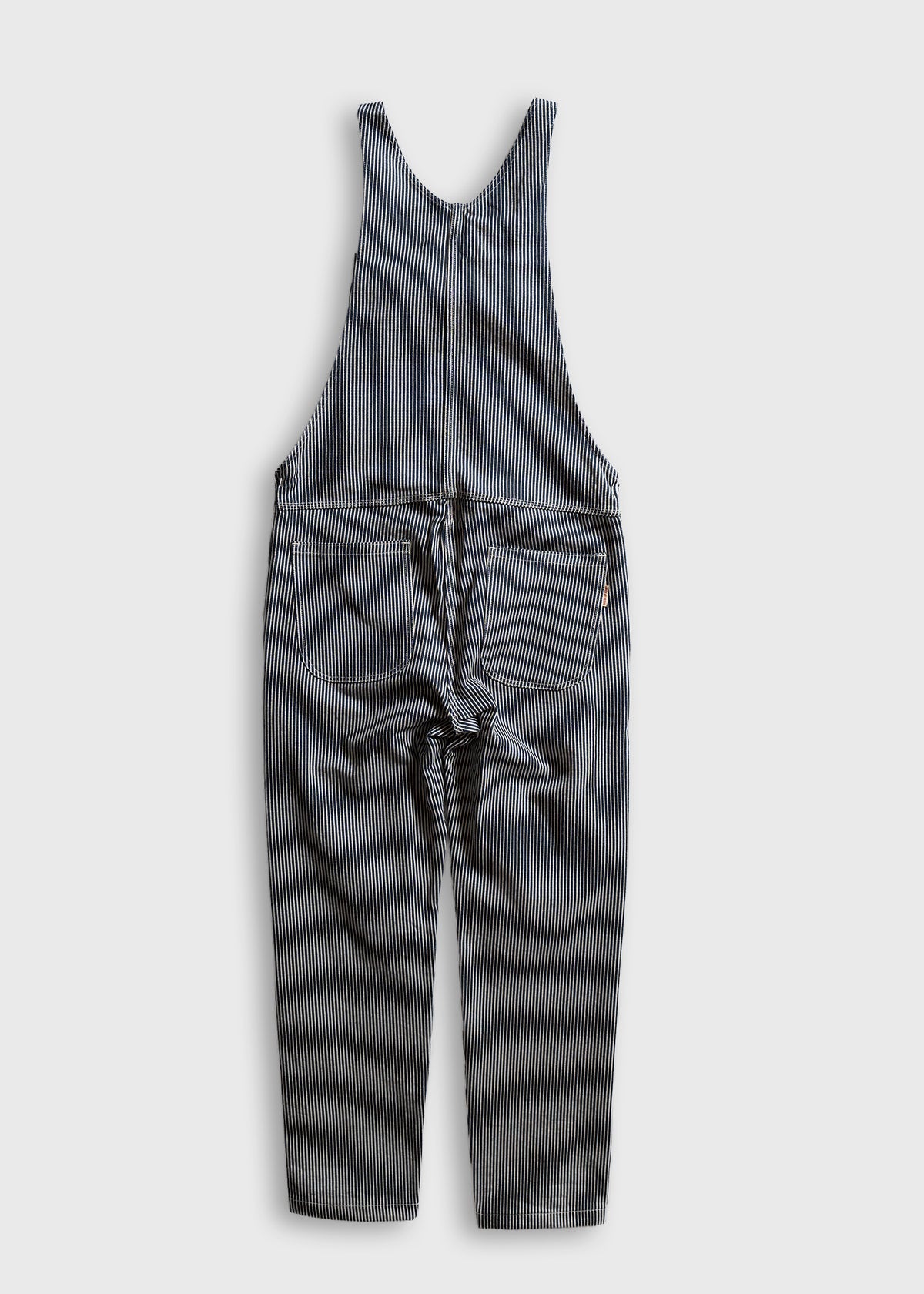Blue and white striped overalls with pockets, laid flat on a white background, showcasing casual, vintage-inspired fashion.