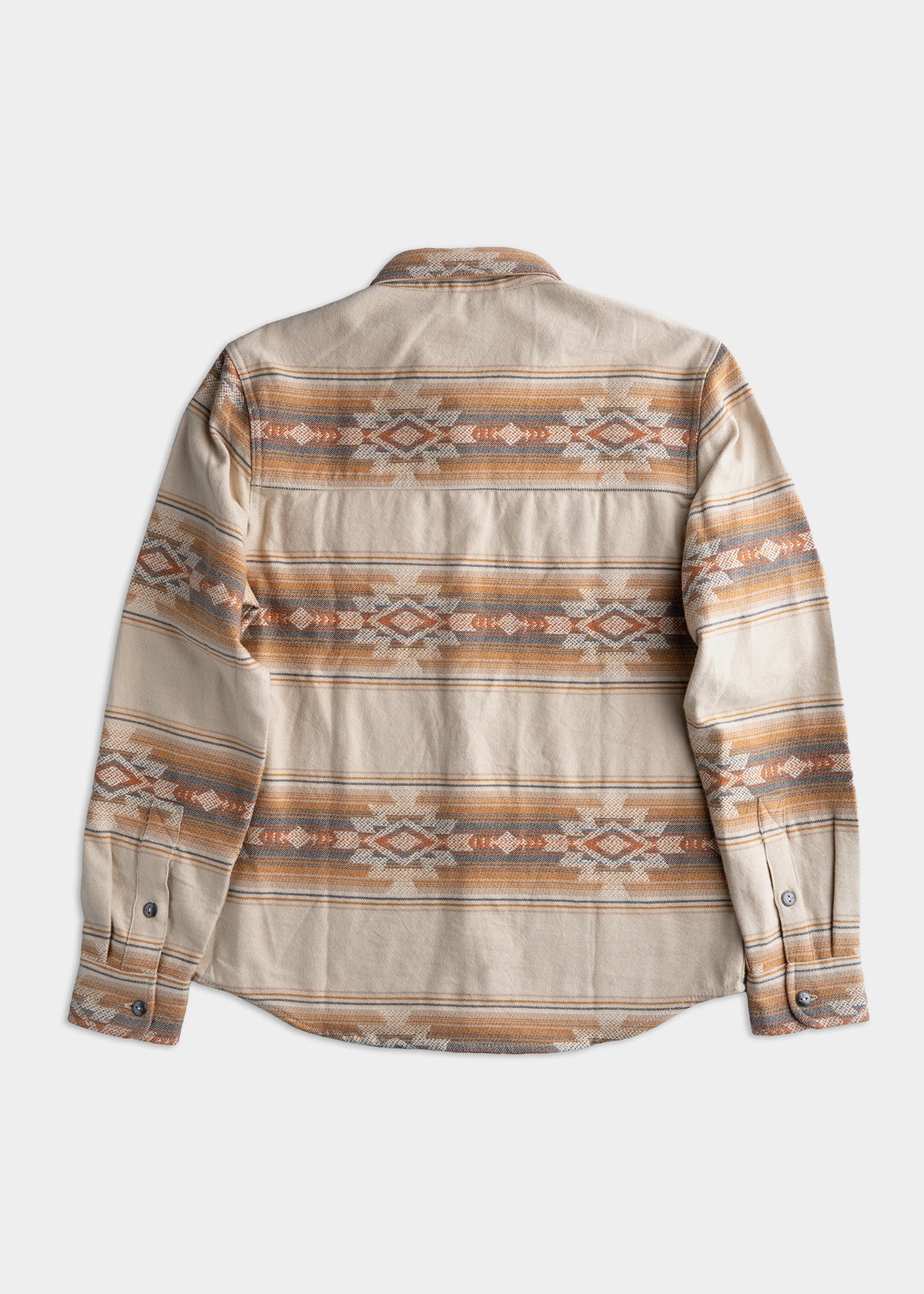 Beige shirt with geometric patterns in orange and gray, featuring long sleeves and buttoned cuffs, laid flat on a white background.