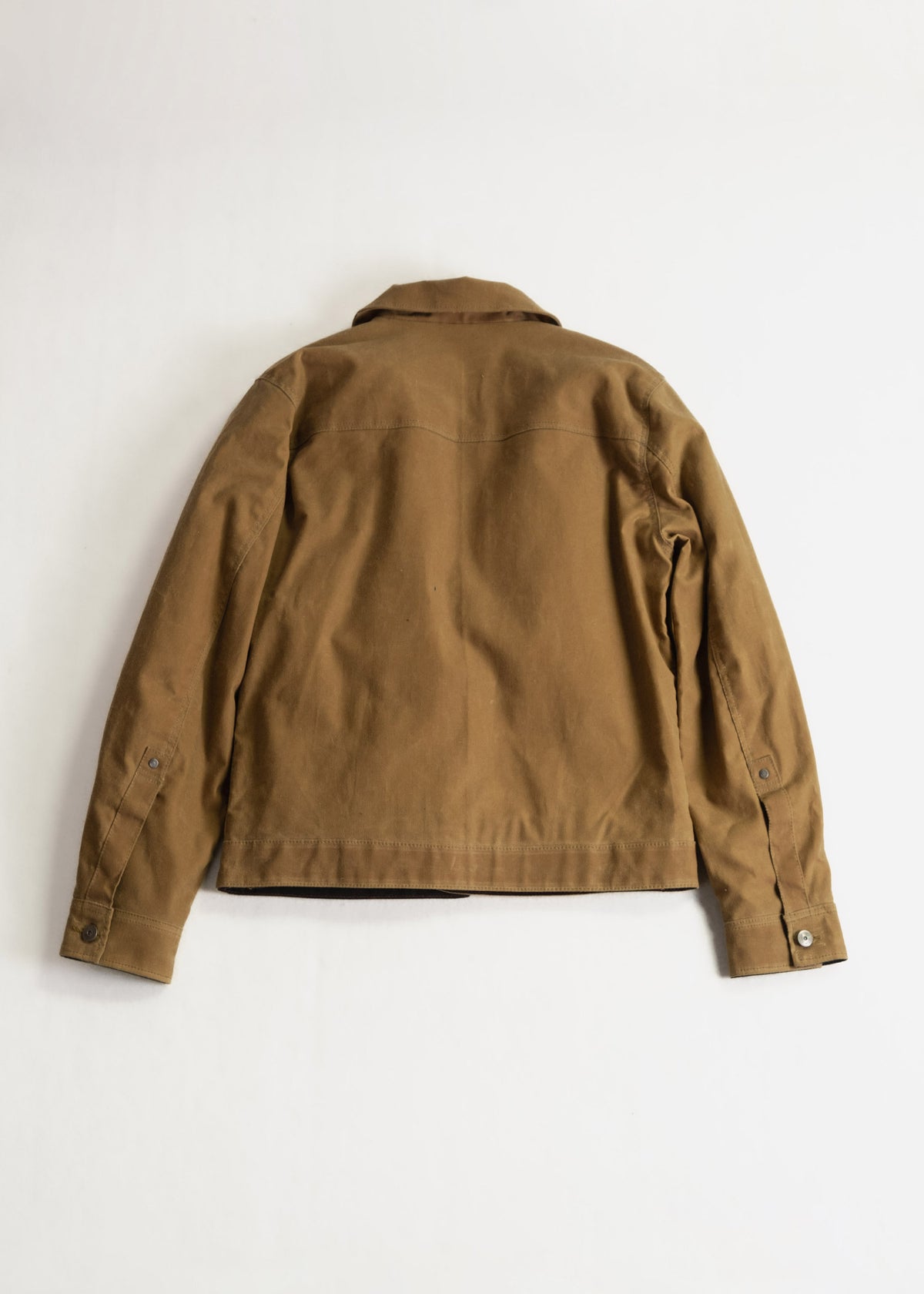 Brown jacket shown from the back on a plain white background, highlighting its simple design and buttoned cuffs.