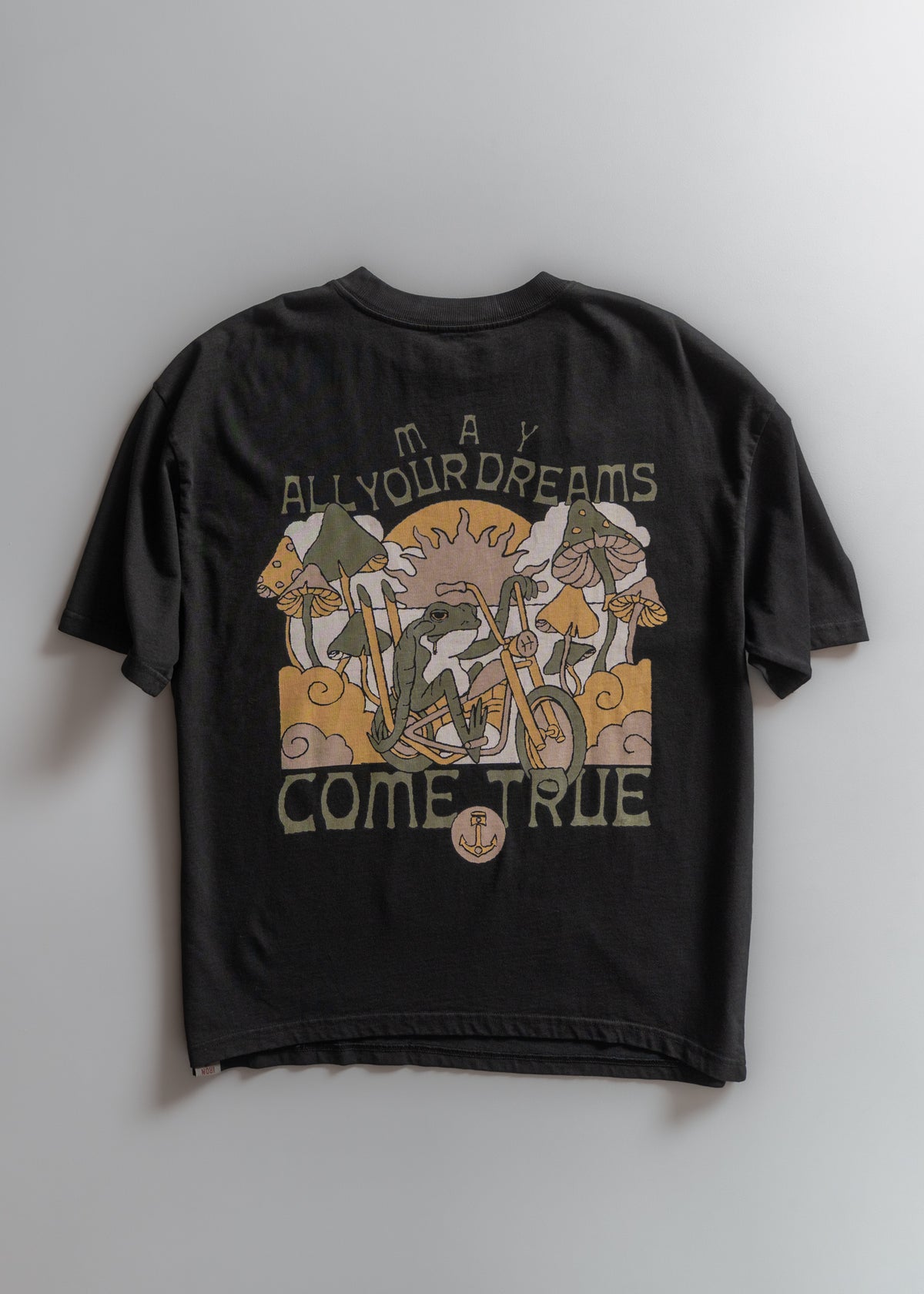 Black T-shirt with colorful mushroom and sun design, text reads "May All Your Dreams Come True" in bold letters.