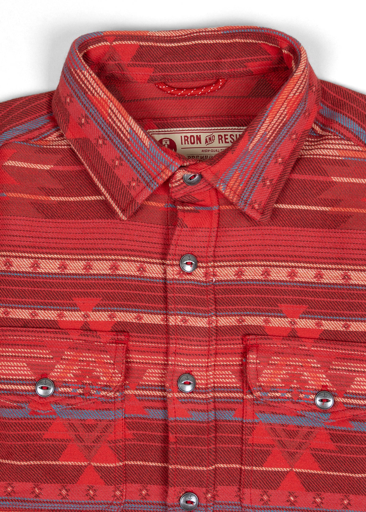 Red patterned shirt with geometric designs, buttoned pockets, and a collar. Label reads "Iron and Resin."