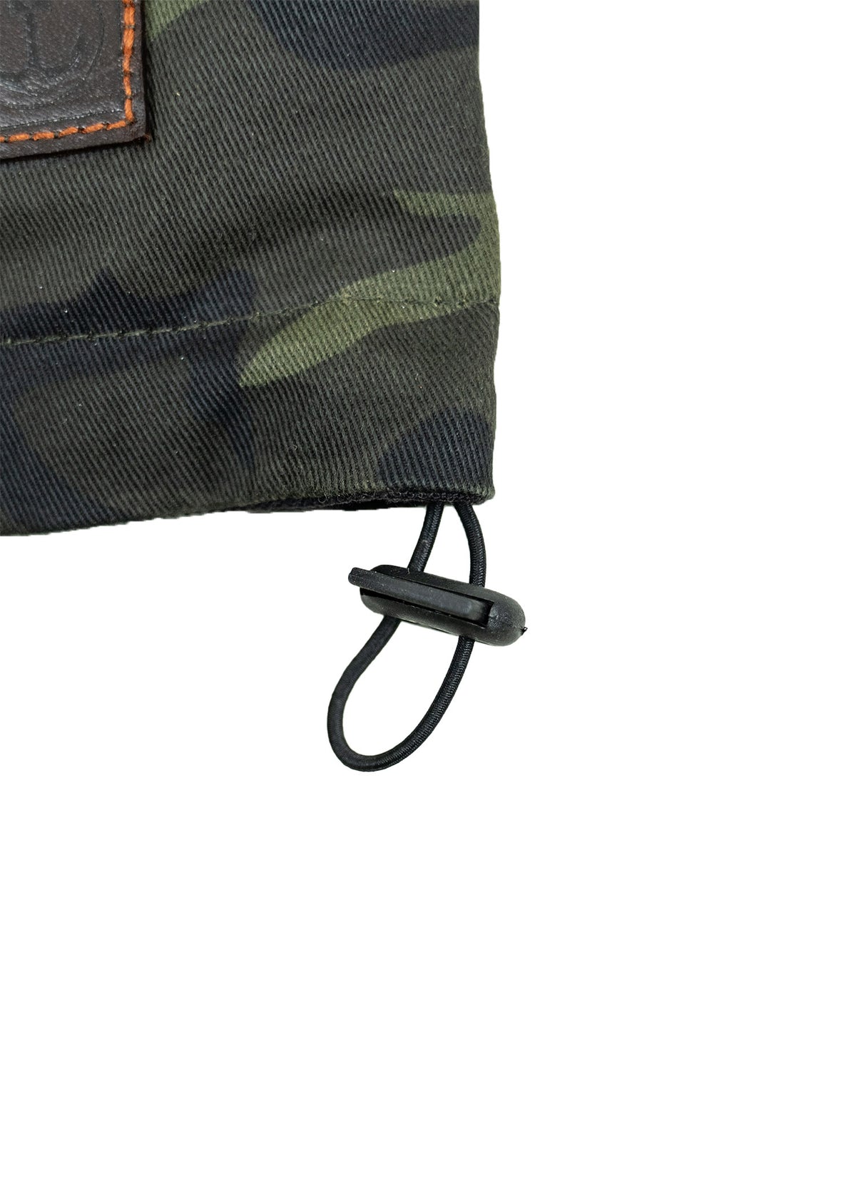 Camouflage fabric with a leather patch and adjustable black drawstring.