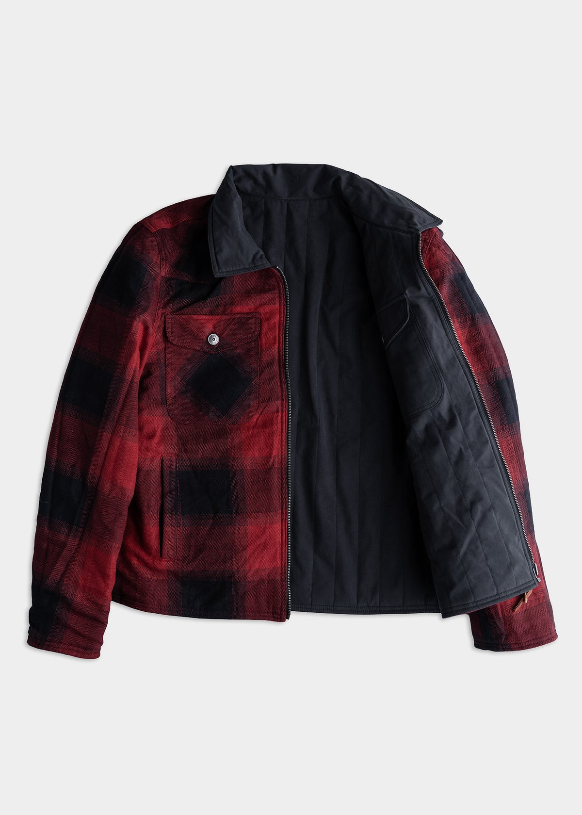 Red and black plaid jacket with open front, showing a dark lining. Features a buttoned chest pocket and zippered closure.