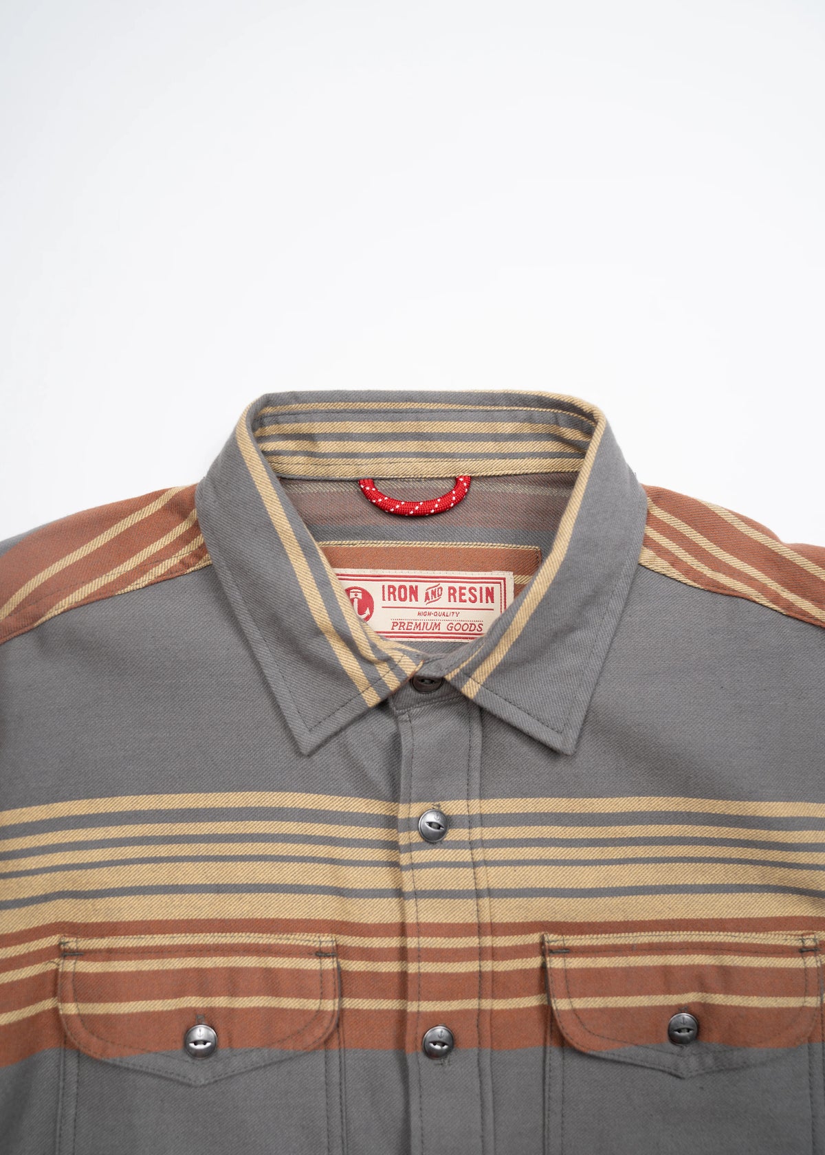 Gray and brown striped button-up shirt with dual chest pockets, featuring an Iron and Resin label, displayed on a white background.