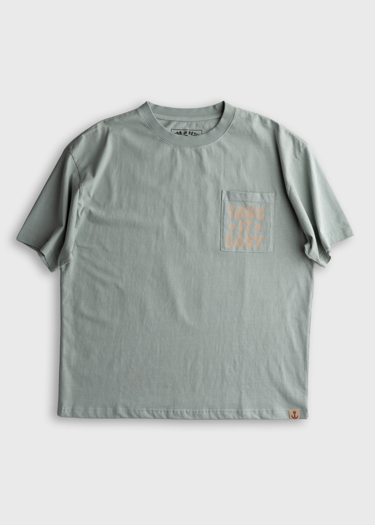 Gray T-shirt with "Take It Easy" on pocket. Simple design, short sleeves, casual style. Perfect for relaxed, everyday wear.