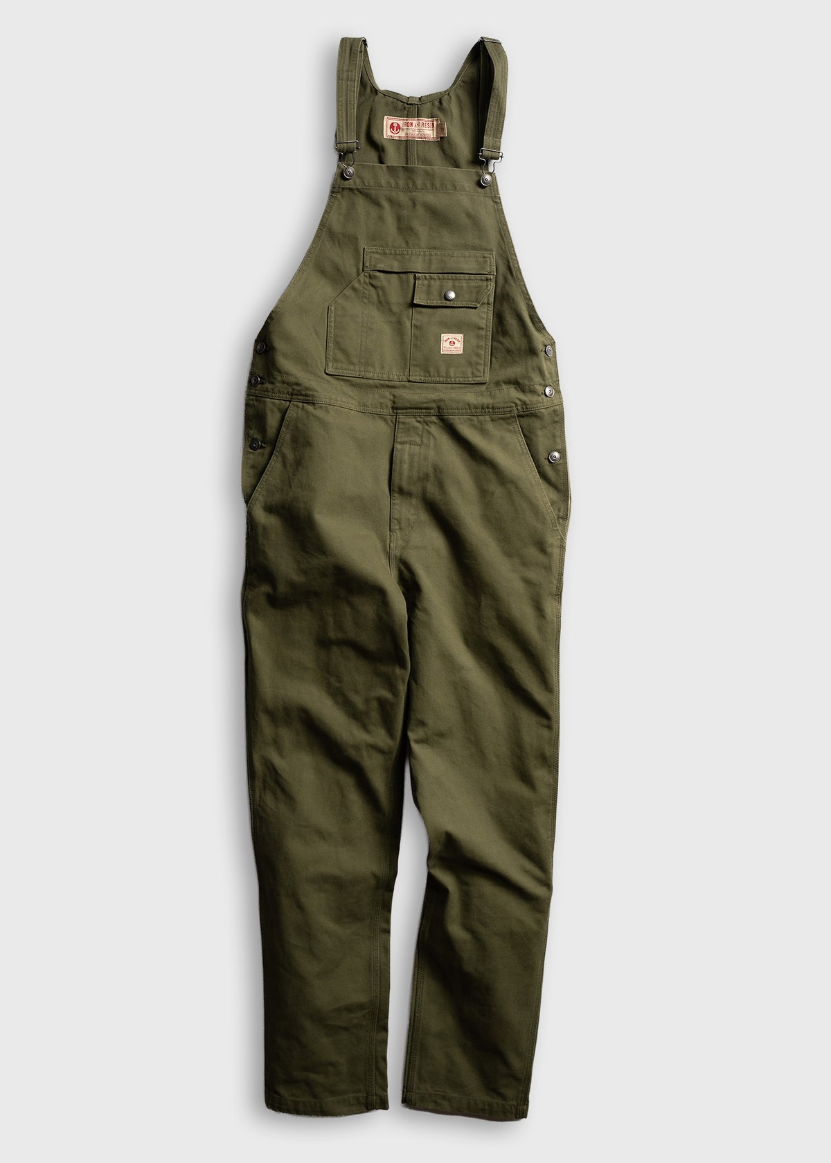 Green cotton overalls with adjustable straps and multiple pockets, displayed on a white background for a casual workwear look.