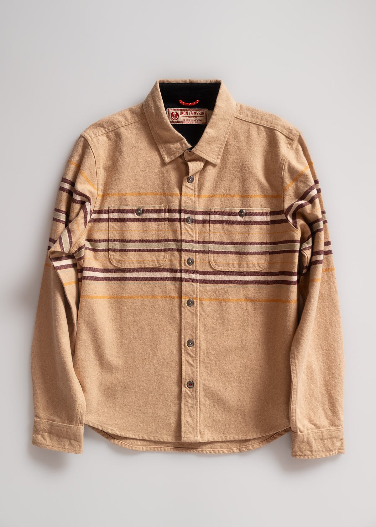 Tan button-up shirt with brown and yellow stripes, featuring two chest pockets. Classic design on a plain white background.