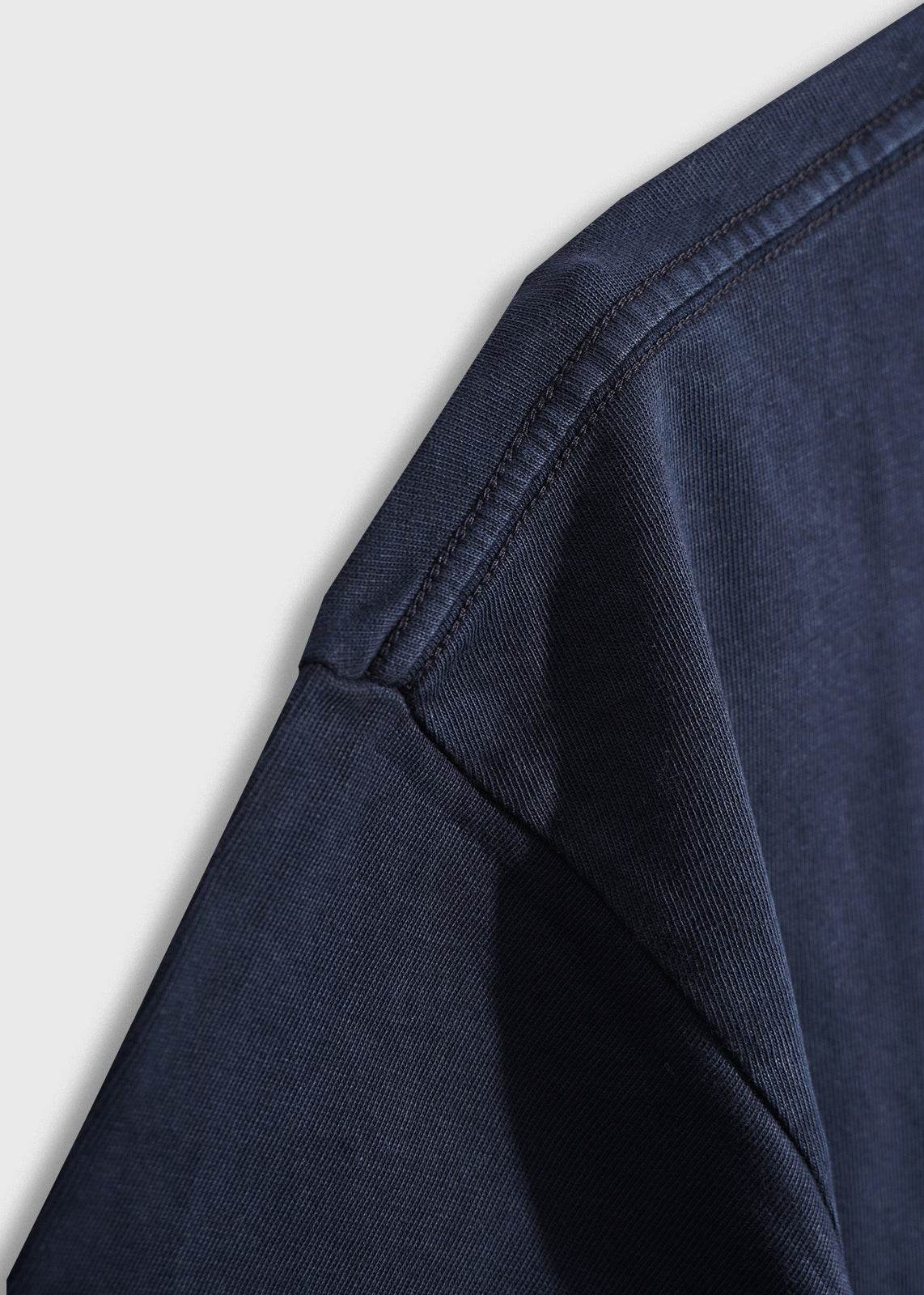 Close-up shot of men’s 7.6 oz cotton, navy pocket tee, showing details of fabric 