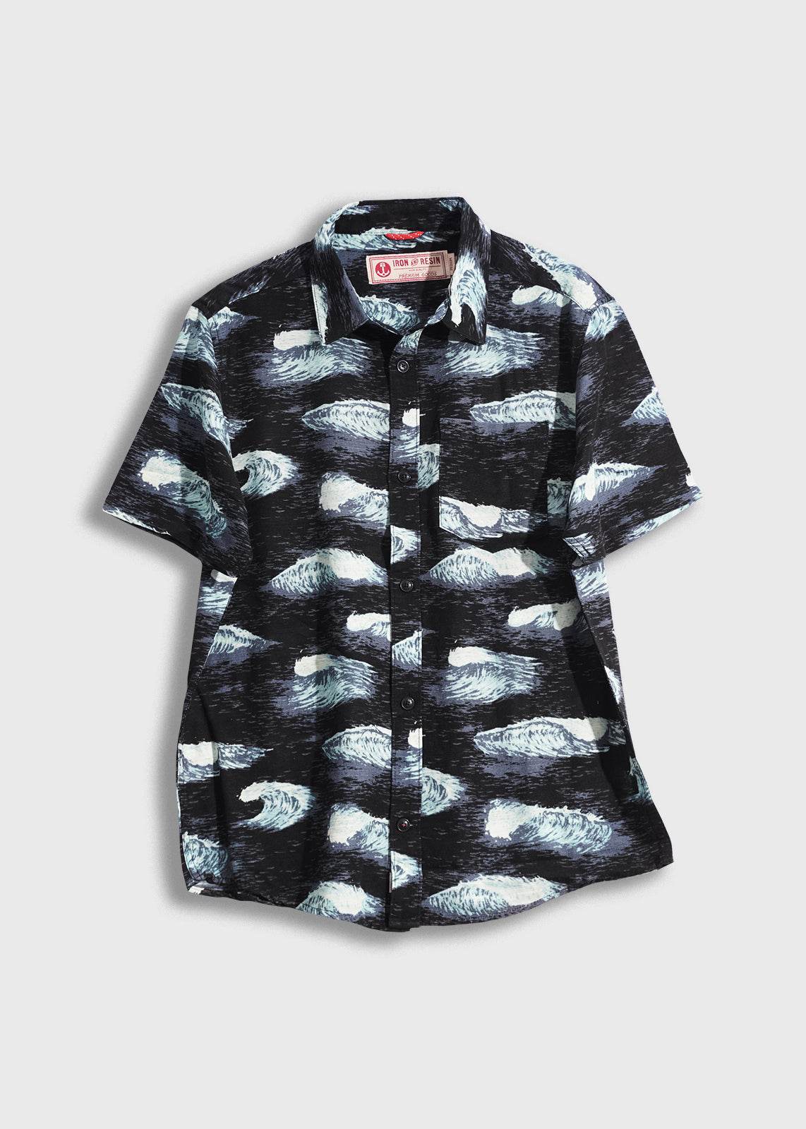 Black short-sleeve shirt with wave pattern, featuring a collar and buttons, displayed on a light background.