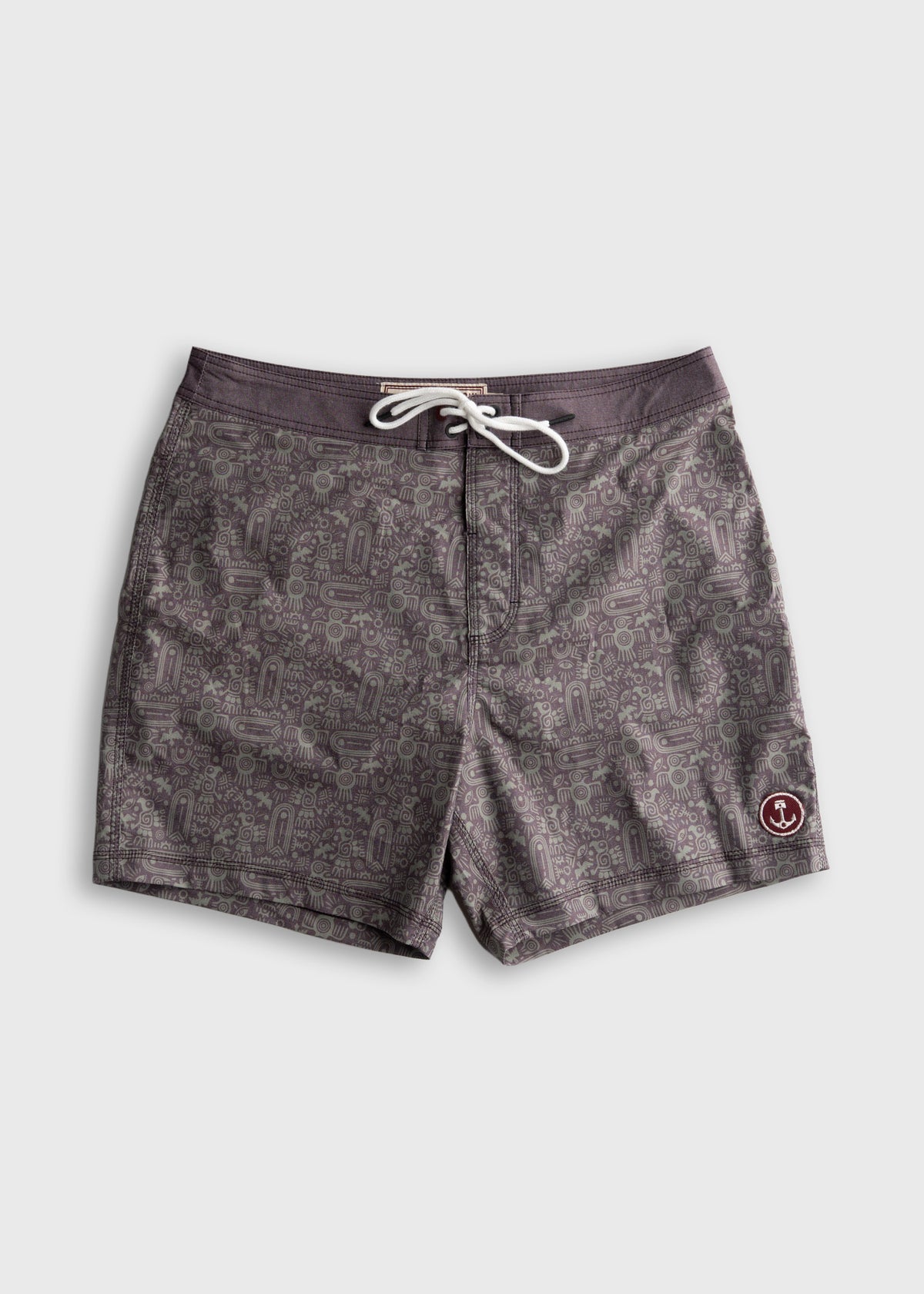 Gray swim trunks with intricate patterns and a drawstring, featuring a small anchor logo on the lower right.