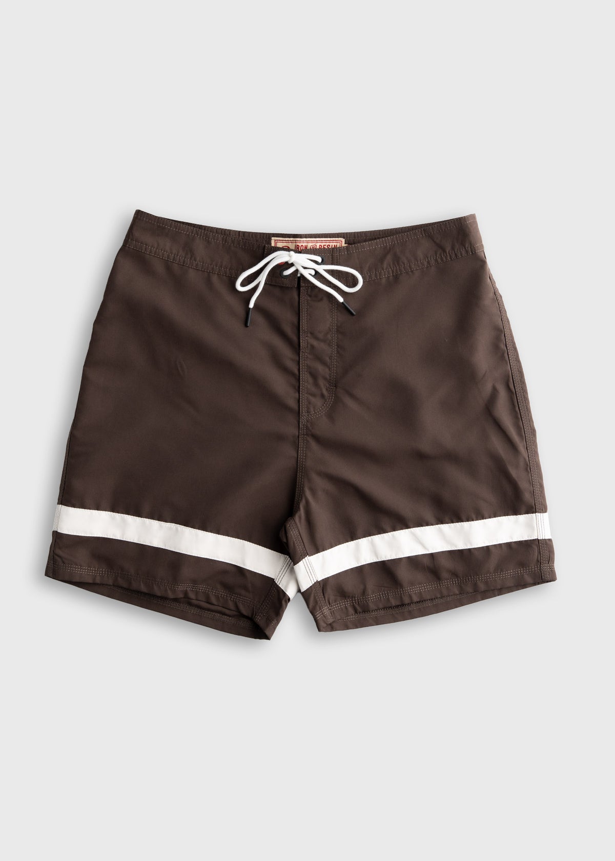 Brown swim trunks with white stripes and a drawstring waistband, displayed on a plain background, highlighting casual beachwear.