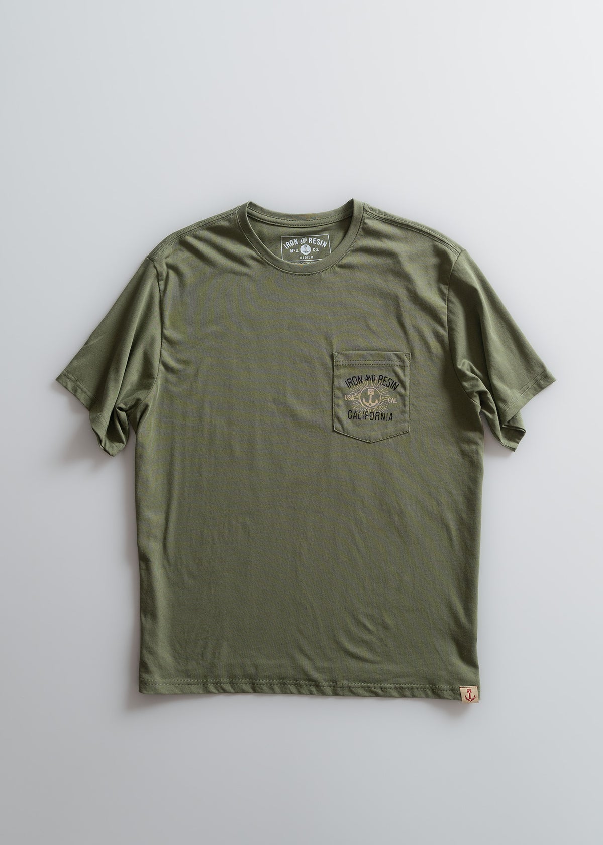 Olive green T-shirt with "Iron and Resin California" logo on chest pocket, displayed on a plain background.