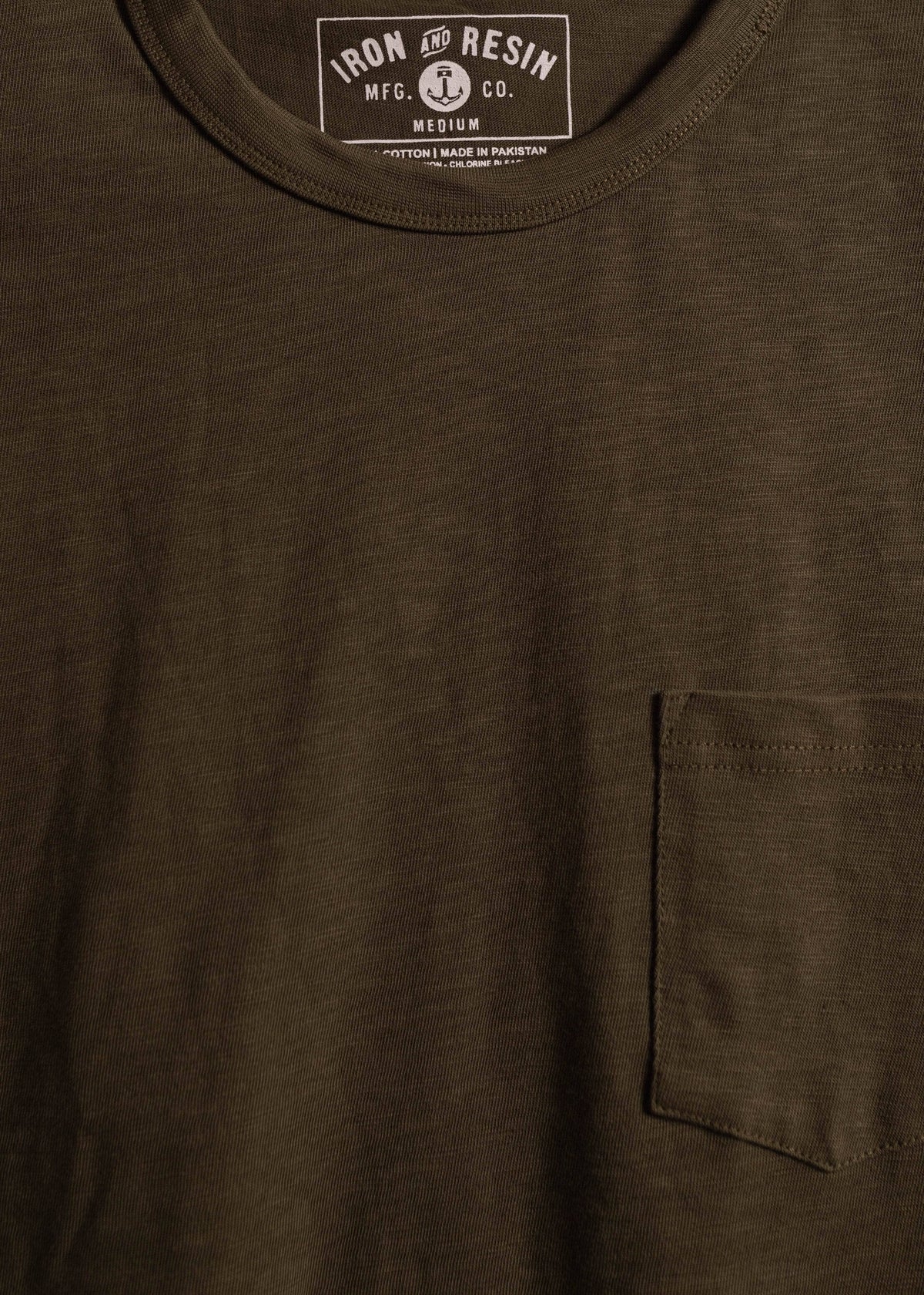 Close up of garment dyed cotton slub shirt showing chest pocket detail and textured fabric with relaxed workwear finish