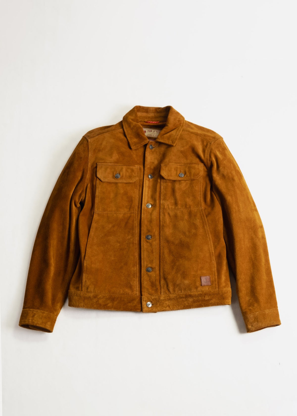 Brown suede jacket with buttoned front and two chest pockets, displayed against a white background.