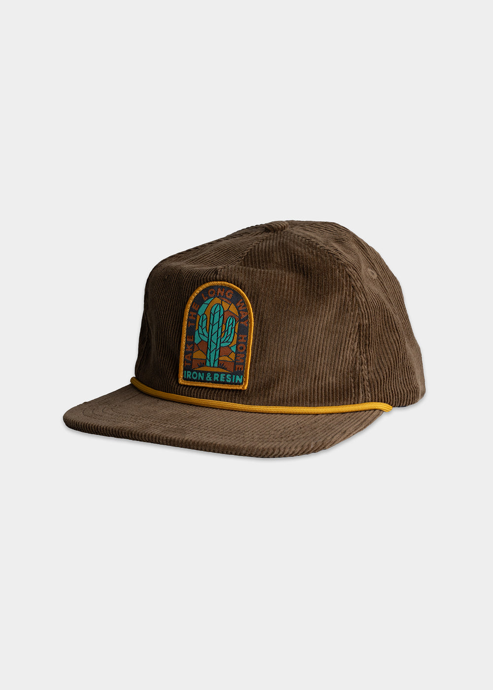 Brown corduroy cap with a colorful patch featuring a cactus design and "Iron & Resin" text, accented by a yellow cord.