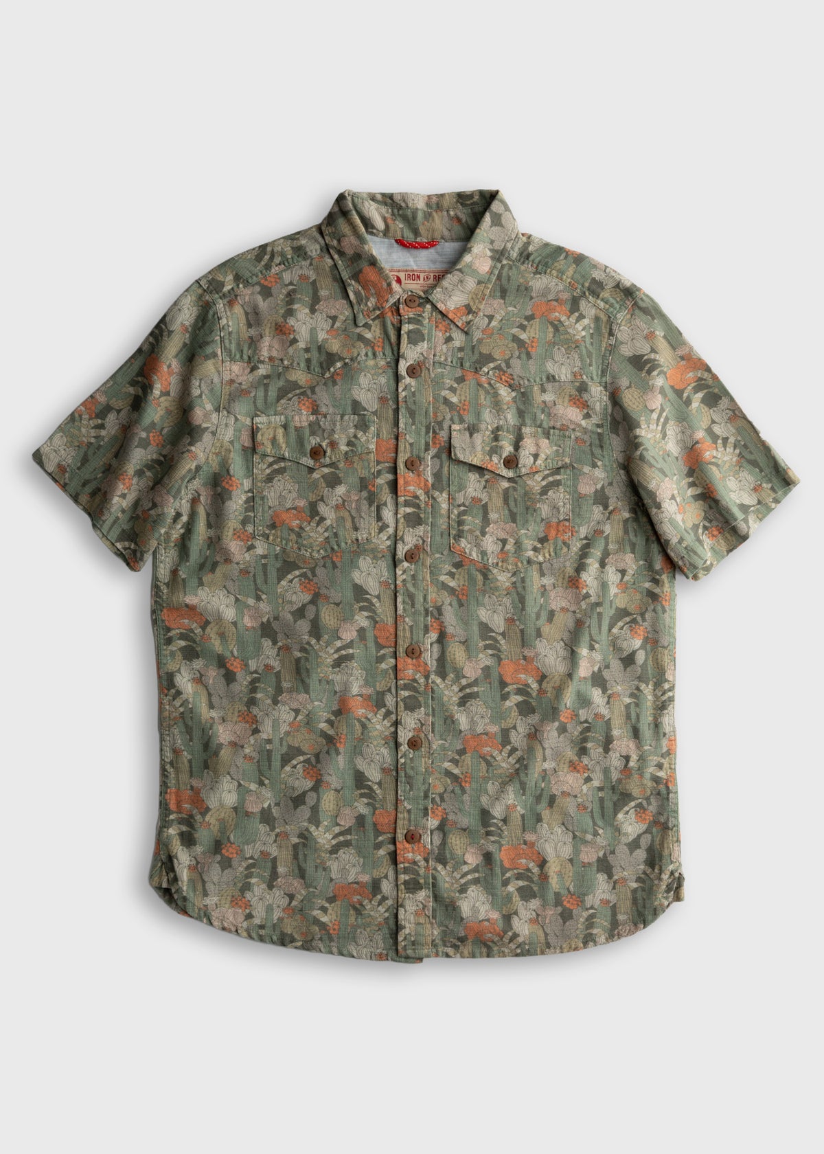 Short-sleeve button-up shirt with a green cactus pattern and chest pockets, set against a plain white background.