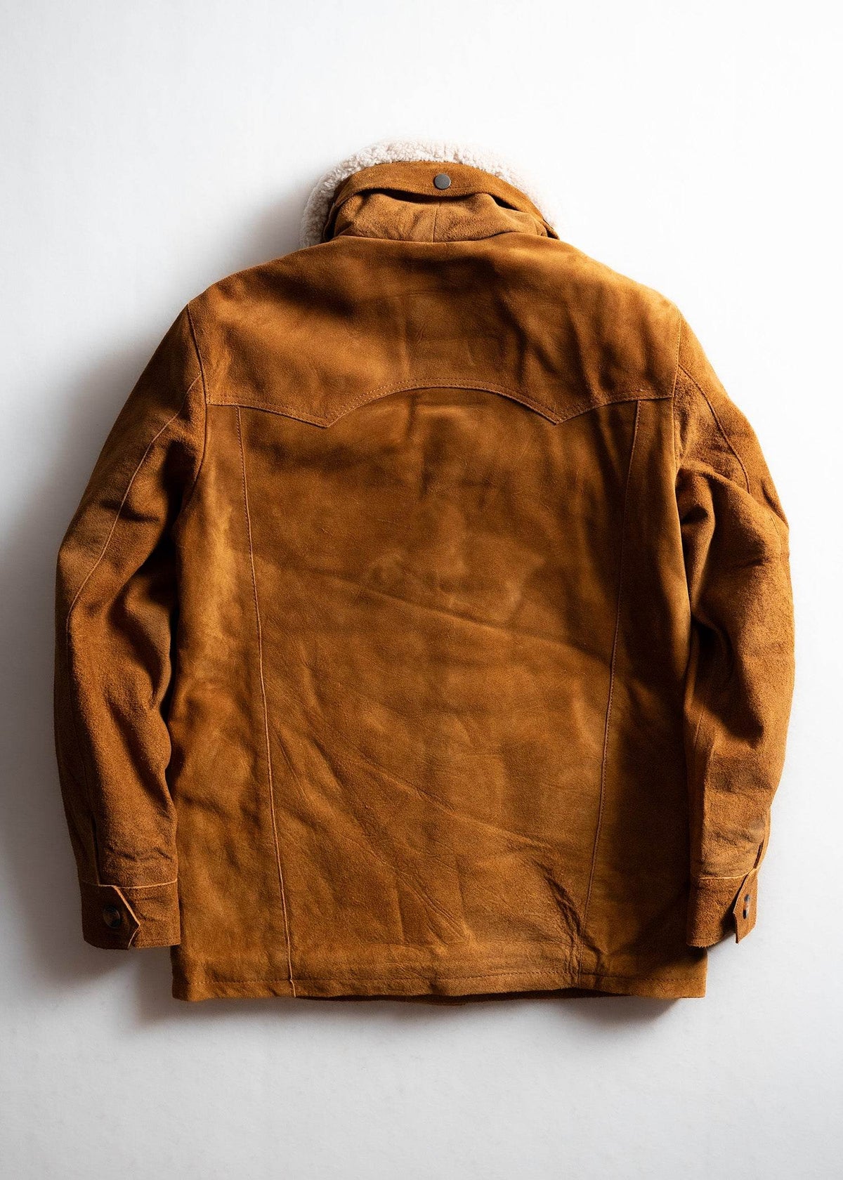 Brown suede jacket with shearling collar, buttoned cuffs, and back yoke detail, displayed on a white background.