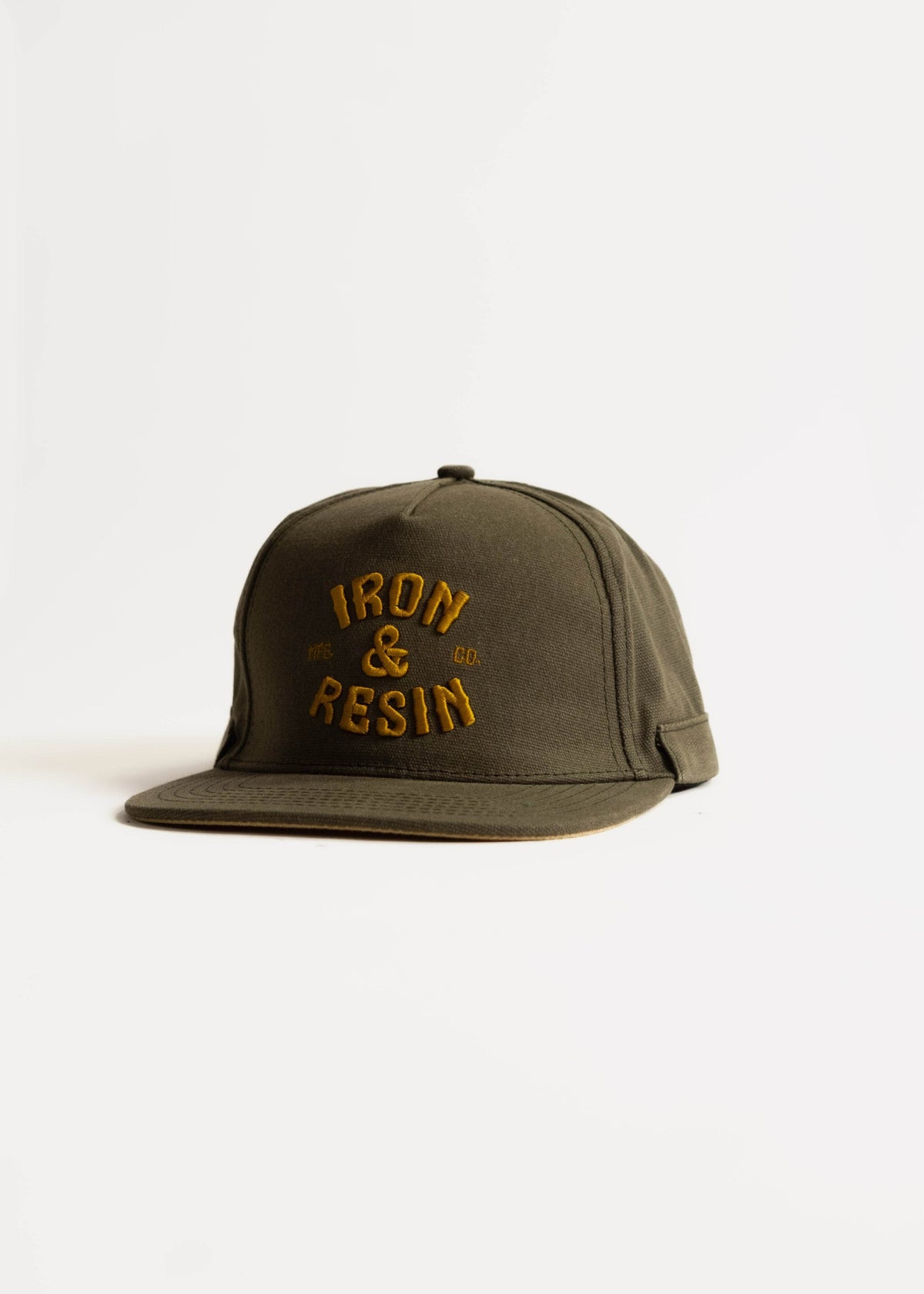 Green cap with "Iron & Resin" in yellow text on front, displayed against a white background. Simple, stylish design.