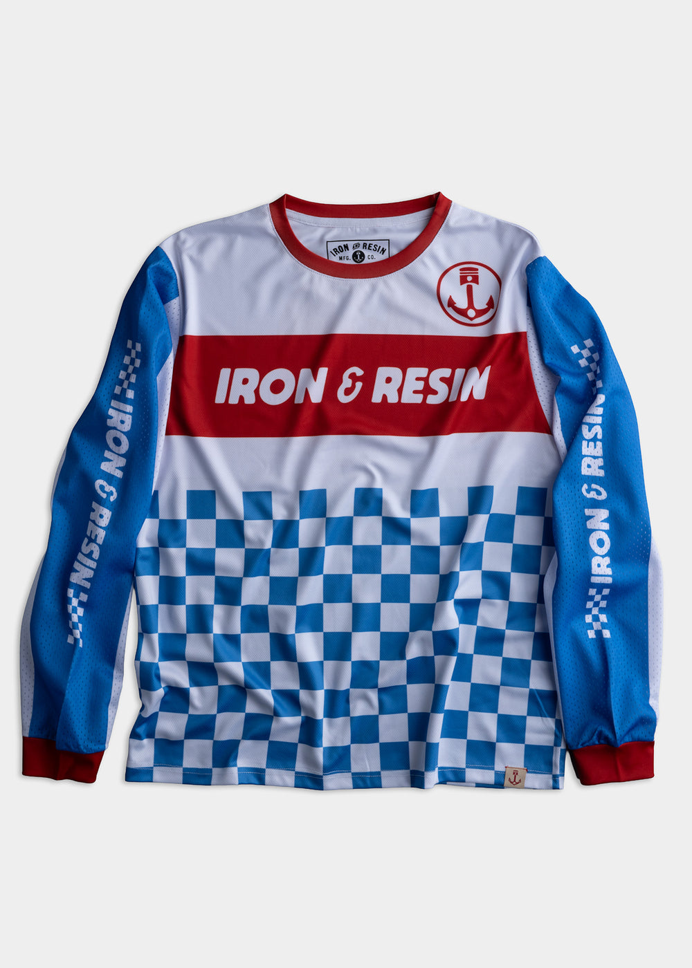 Iron & Resin jersey with red logo, blue sleeves, and checkered pattern, combining style and sporty design in vibrant colors.