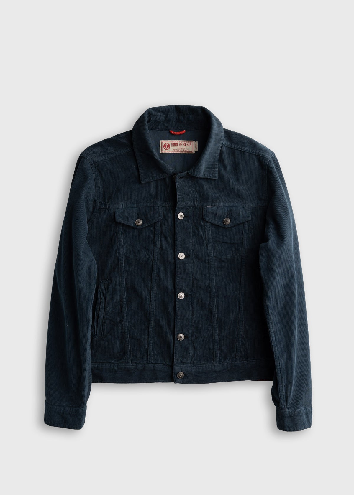 Dark blue corduroy jacket with button closure, two chest pockets, and a collar, displayed on a light gray background.