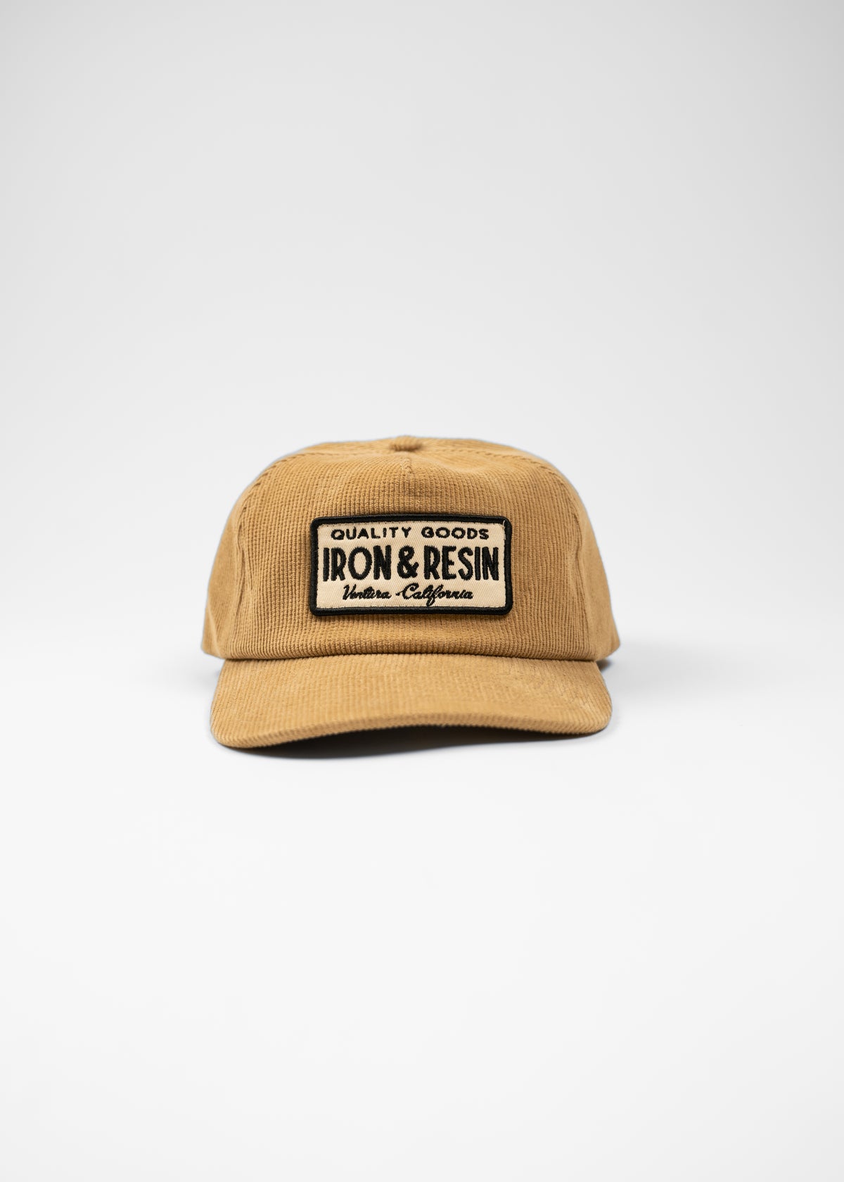 Tan cap with "Iron & Resin" patch, displaying "Quality Goods" and "Ventura, California" text, on a plain white background.