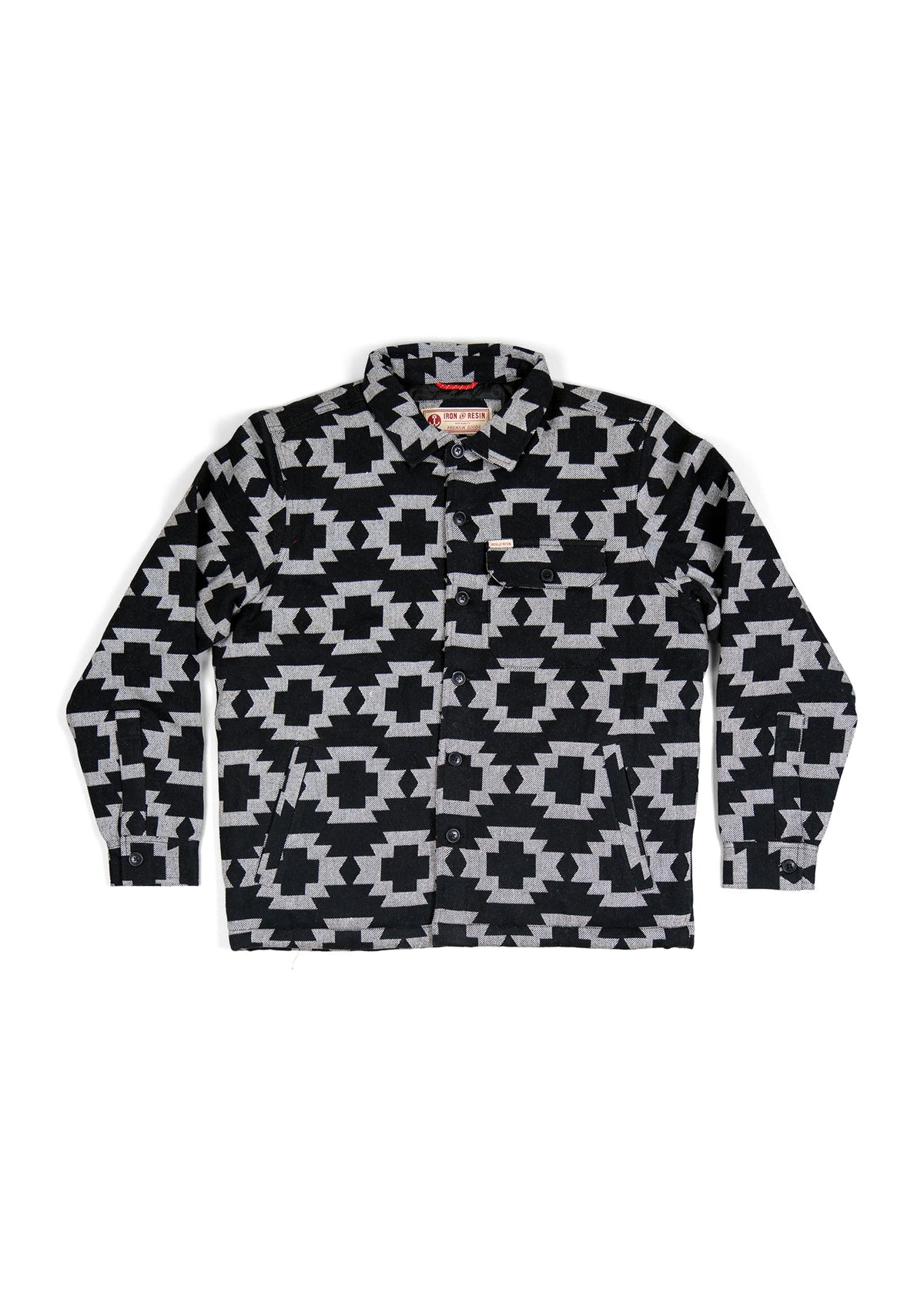 Black and gray geometric patterned jacket with button closure and pockets, laid flat on a white background.
