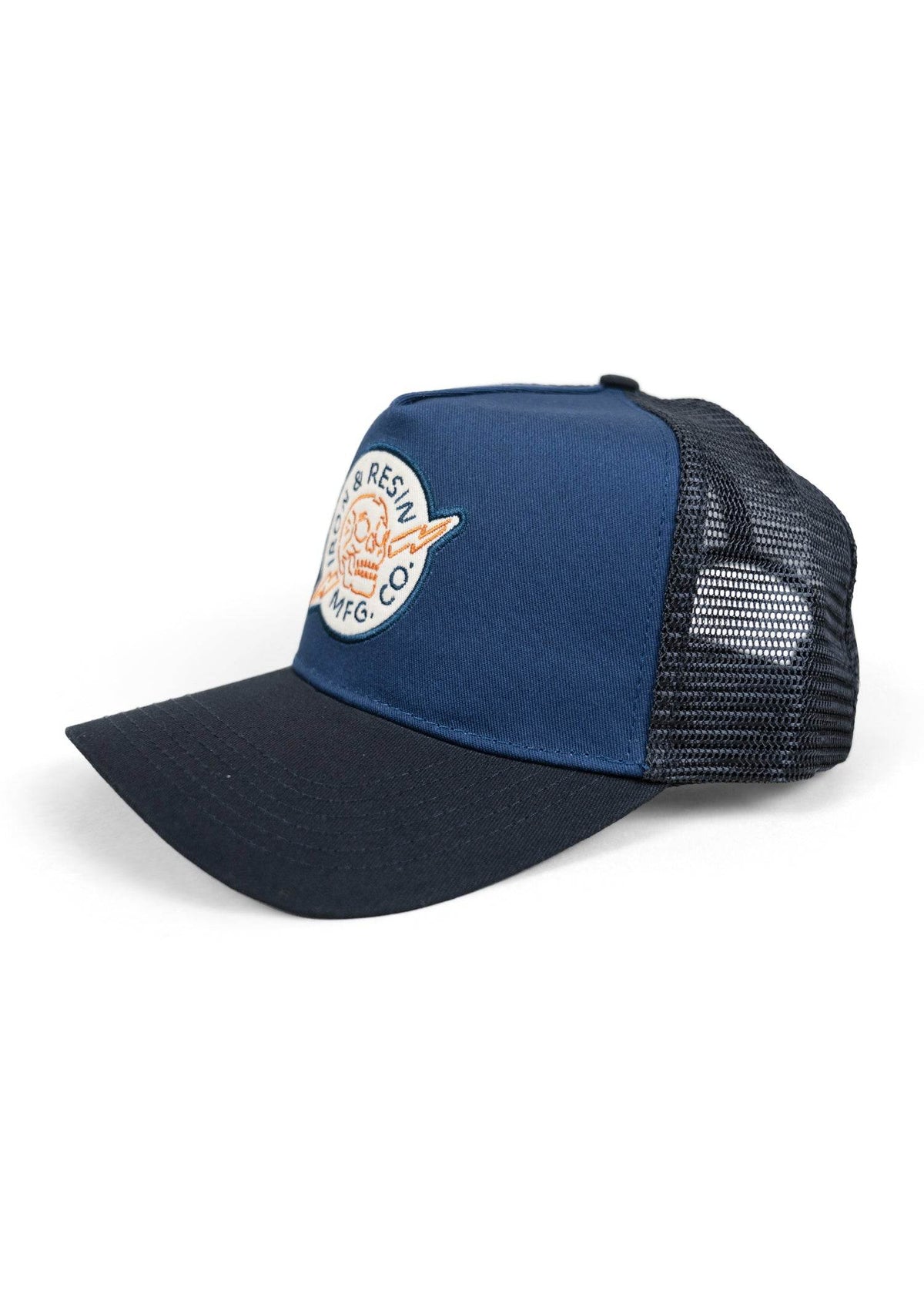 Blue and black trucker cap with mesh back and a patch featuring a skull and lightning bolt design on the front panel.