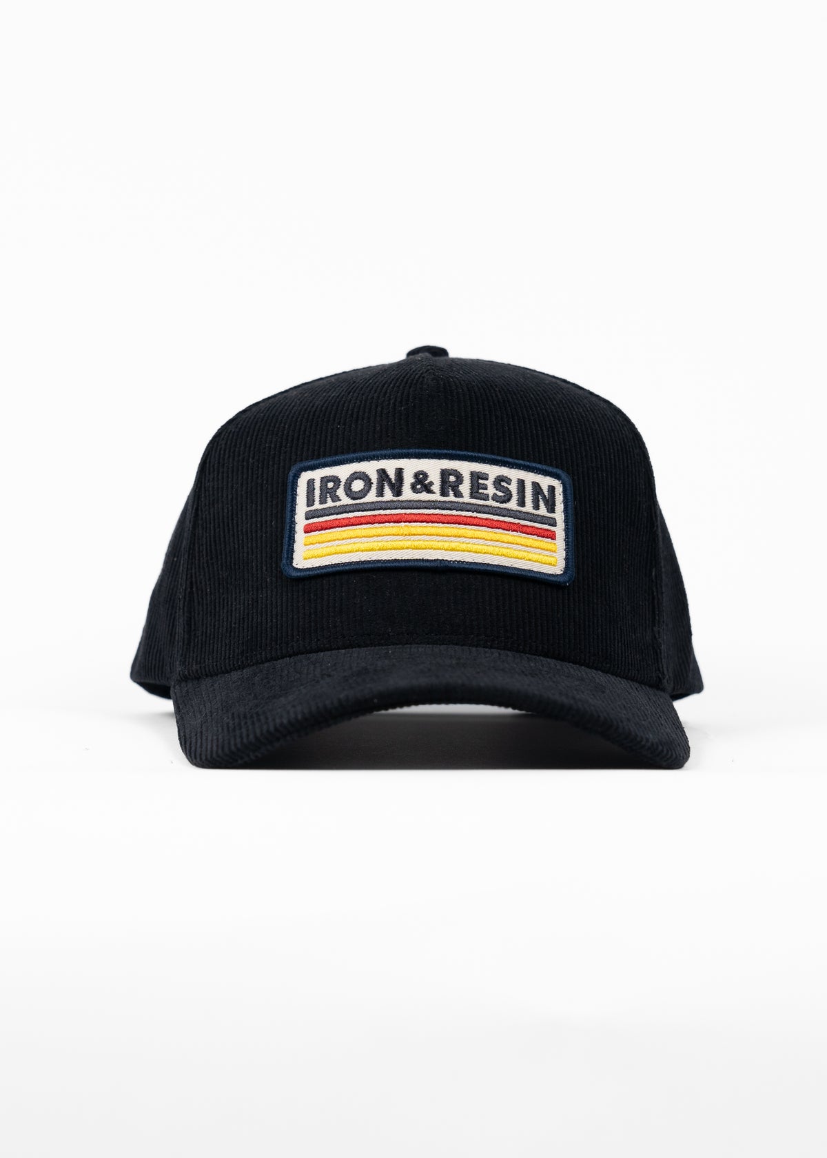 Black cap with "IRON & RESIN" patch featuring colorful stripes, displayed against a white background.