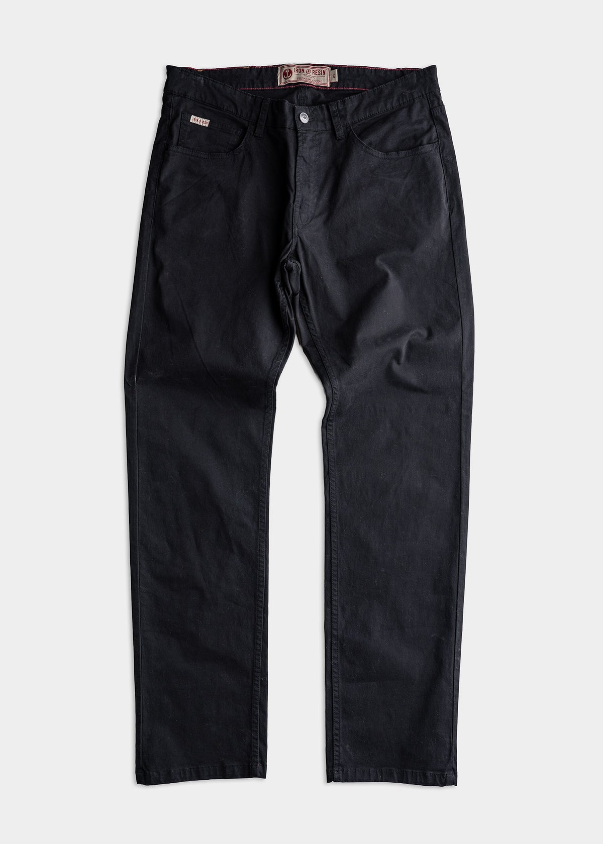 Black denim pants with button closure and front pockets, displayed flat on a white background. Iron & Resin label visible inside.