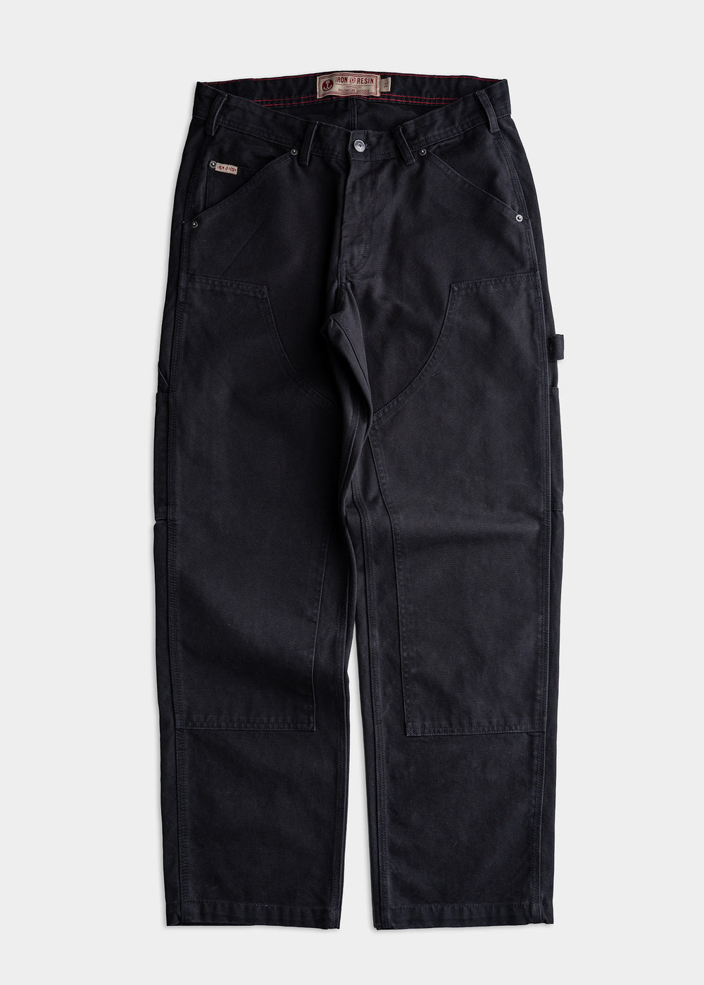 Black work pants with reinforced knees and multiple pockets, displayed flat on a white background, showcasing durable design.