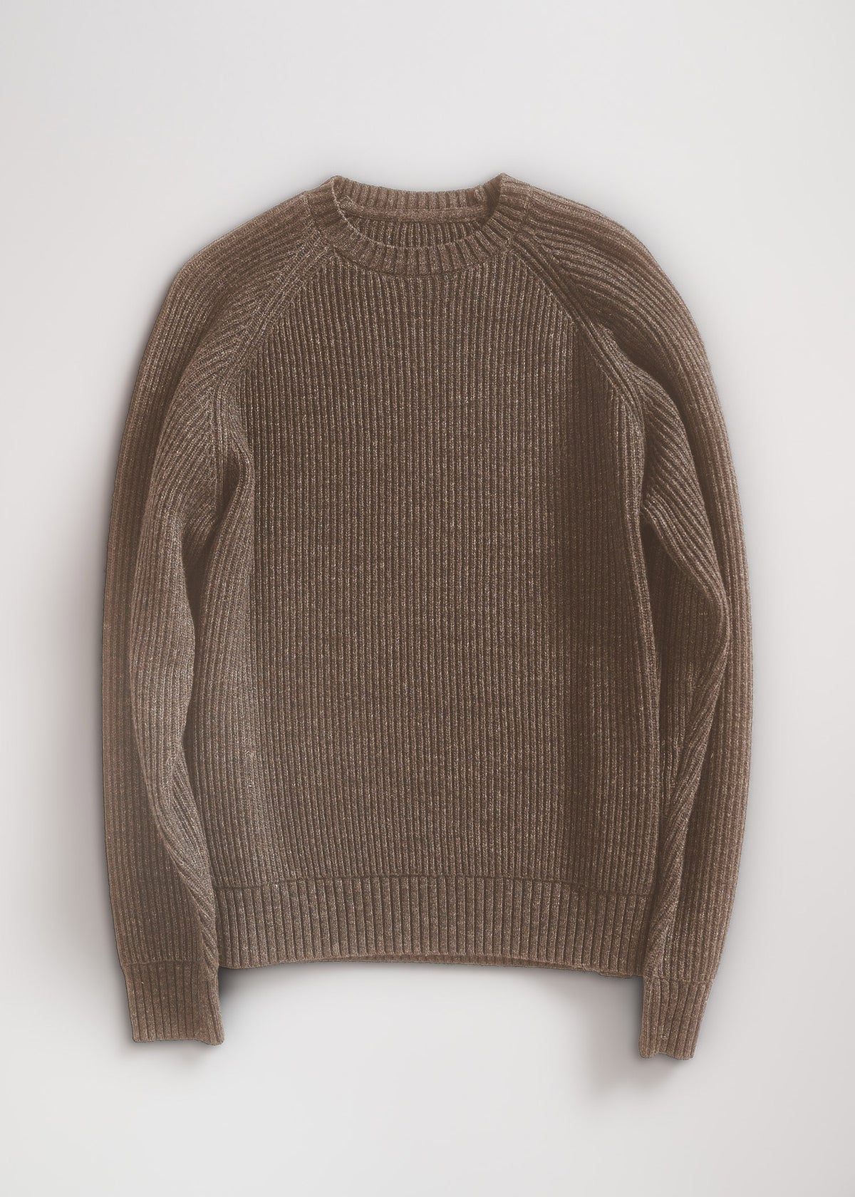 Brown ribbed sweater with long sleeves, laid flat on a light background, showcasing its texture and simple design.