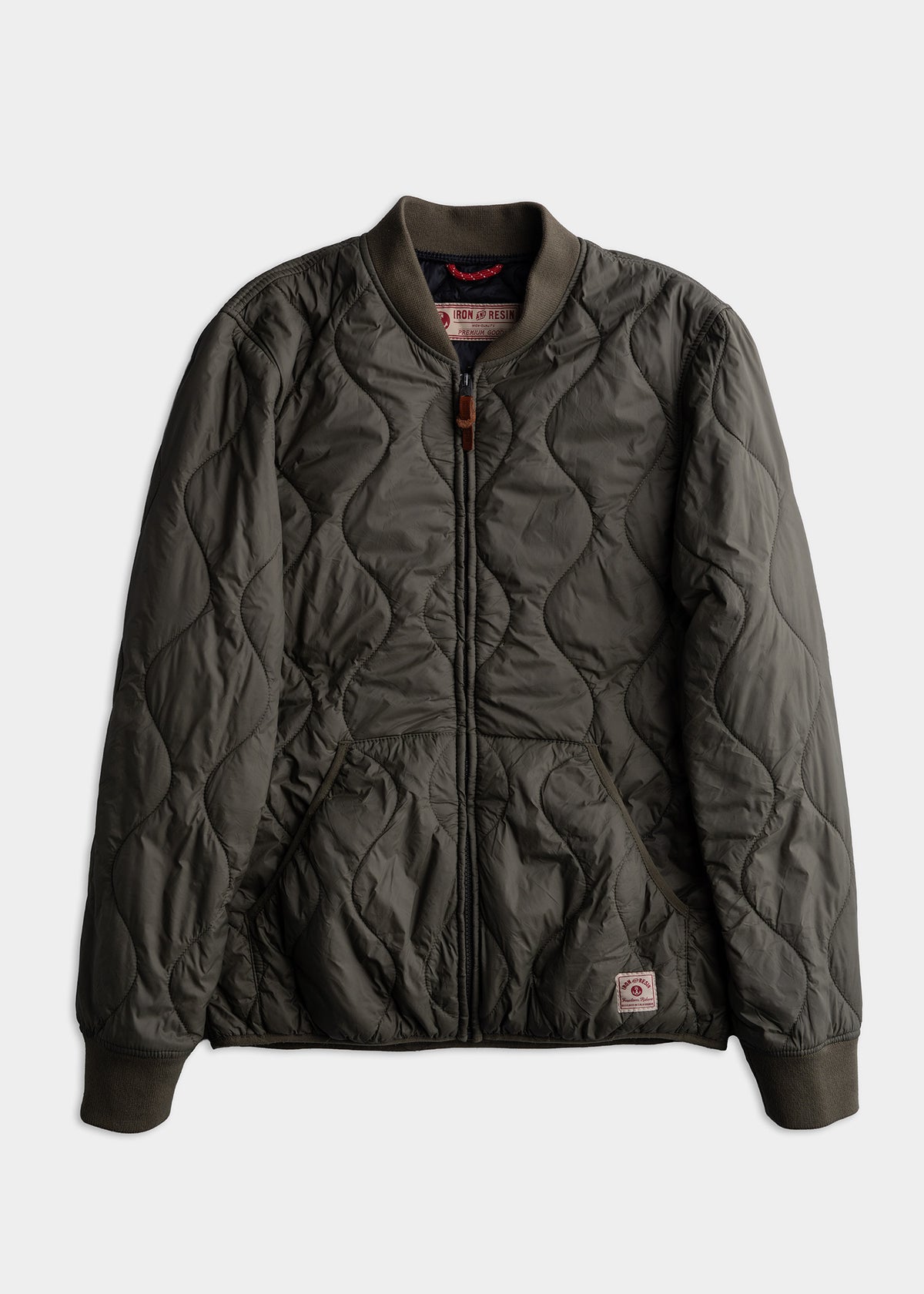 Dark green quilted bomber jacket with ribbed cuffs and collar, featuring a front zipper and two pockets.