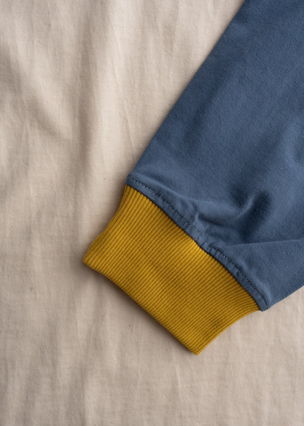 Close up of organic cotton fabric showing soft texture and lightweight 7 oz construction