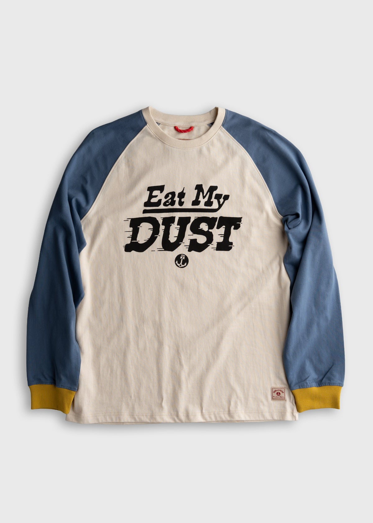 Long-sleeve shirt with blue sleeves and yellow cuffs, featuring bold "Eat My Dust" text on the front.