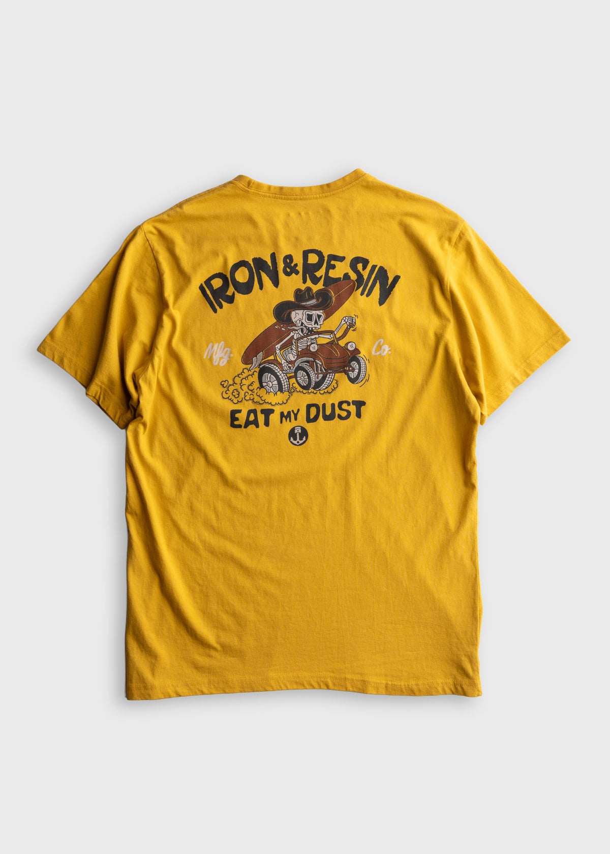 Yellow T-shirt with "Iron & Resin" and "Eat My Dust" text, featuring a skeleton driving a hot rod in a cartoon style.