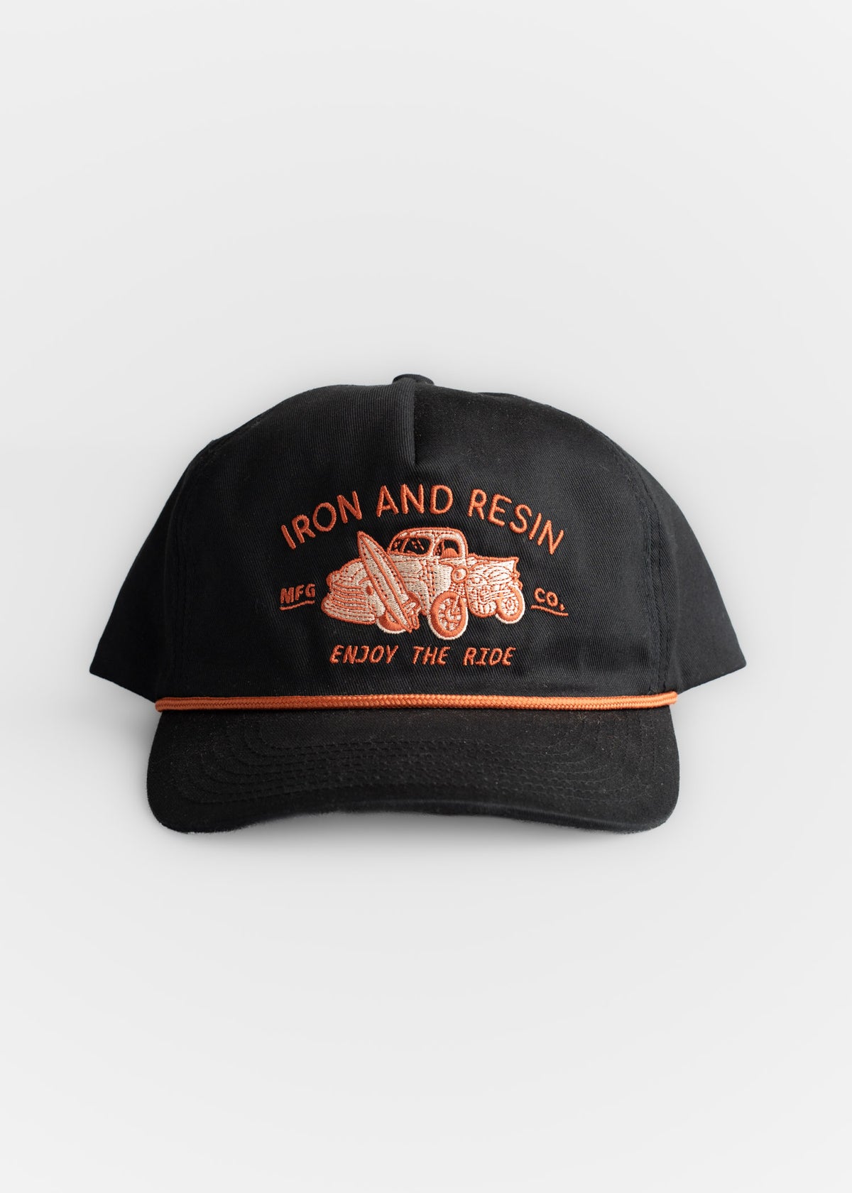 Black cap with orange embroidery of a vintage car and text "Iron and Resin, Enjoy the Ride" on the front.