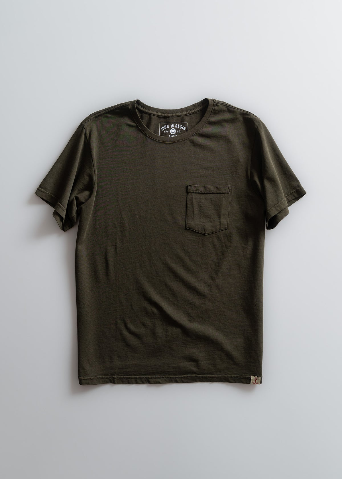 Olive green t-shirt with a chest pocket, short sleeves, and a round neck, displayed on a light background.