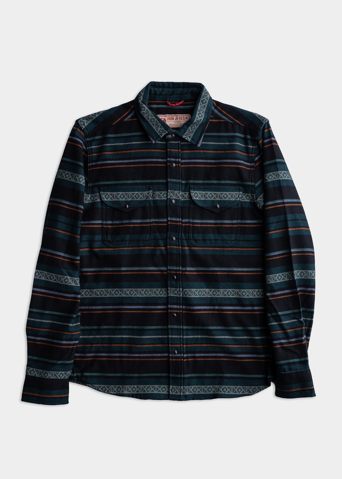 A blue and black striped flannel shirt with buttoned pockets, featuring a geometric pattern, laid flat on a white background.