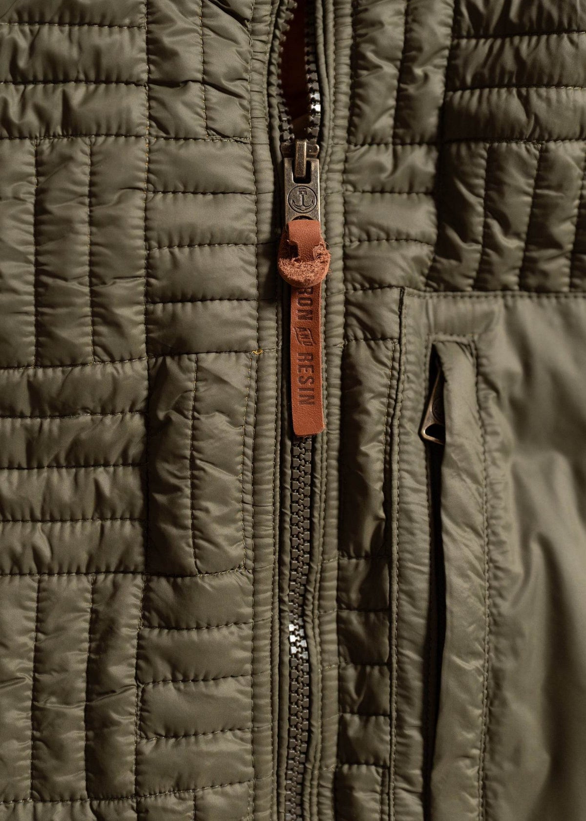 Close up of heavy duty zipper on jacket, highlighting front closure and rugged construction