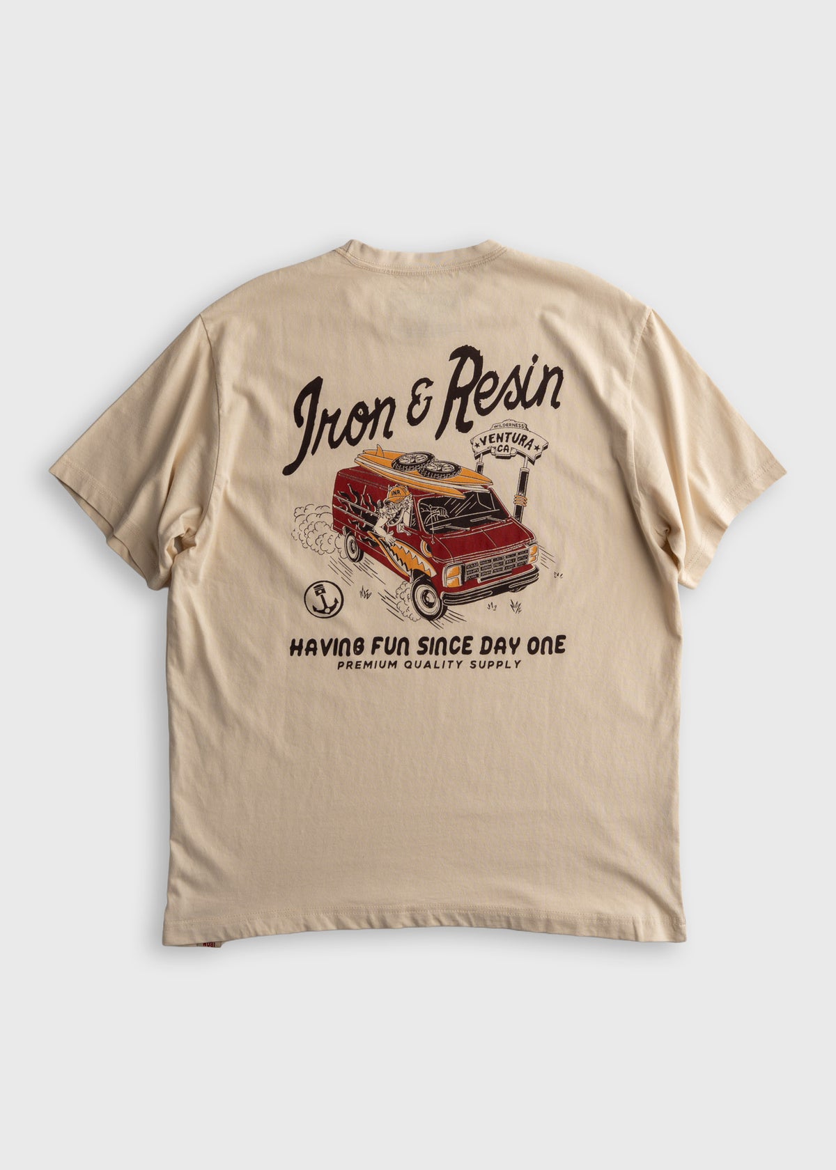 Beige T-shirt with "Iron & Resin" text, vintage van graphic, and "Having Fun Since Day One" slogan, emphasizing adventure.